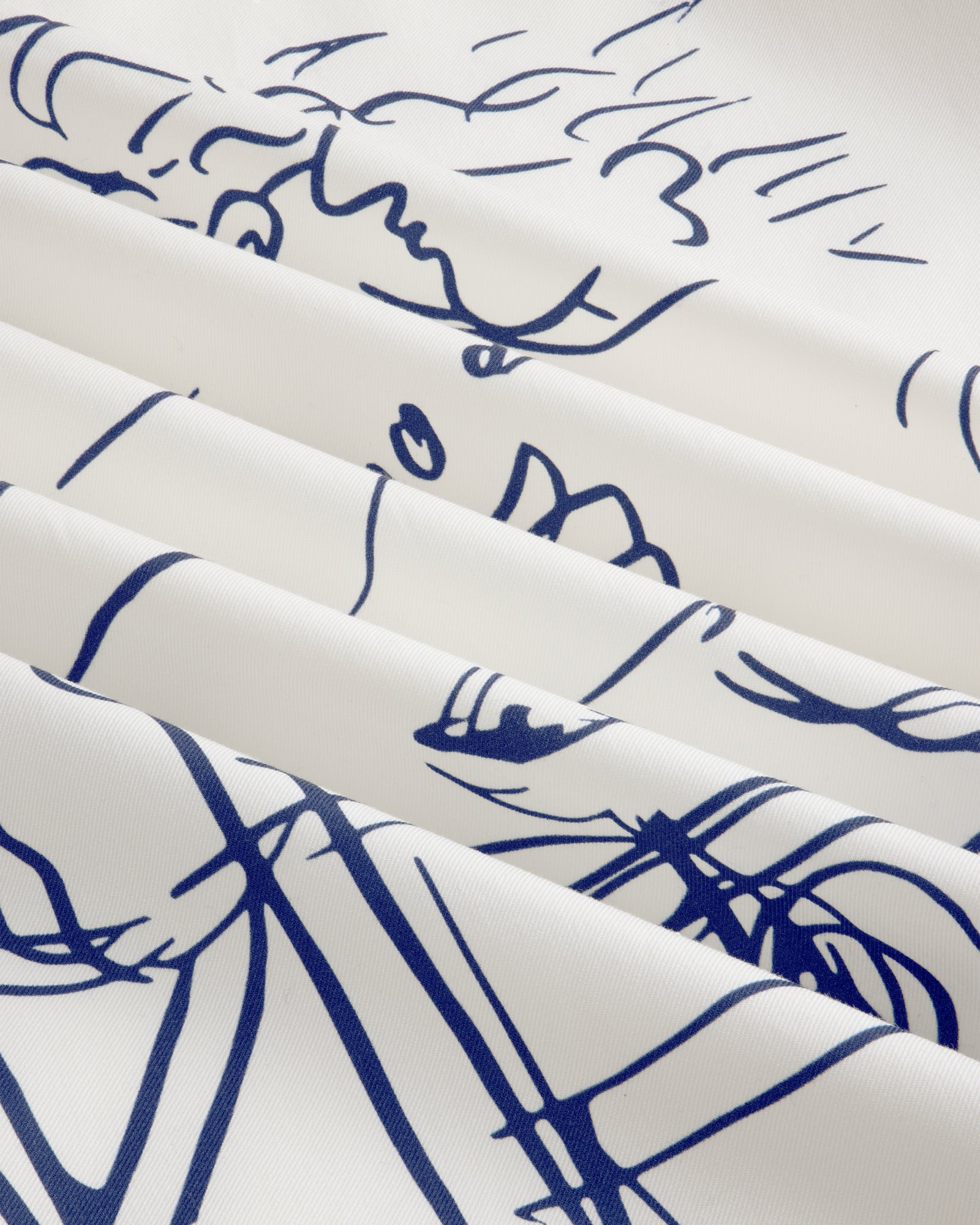 The Fassianos "Rendez - Vous" Camp Shirt features white fabric with thin blue line art and soft, diagonal folds.