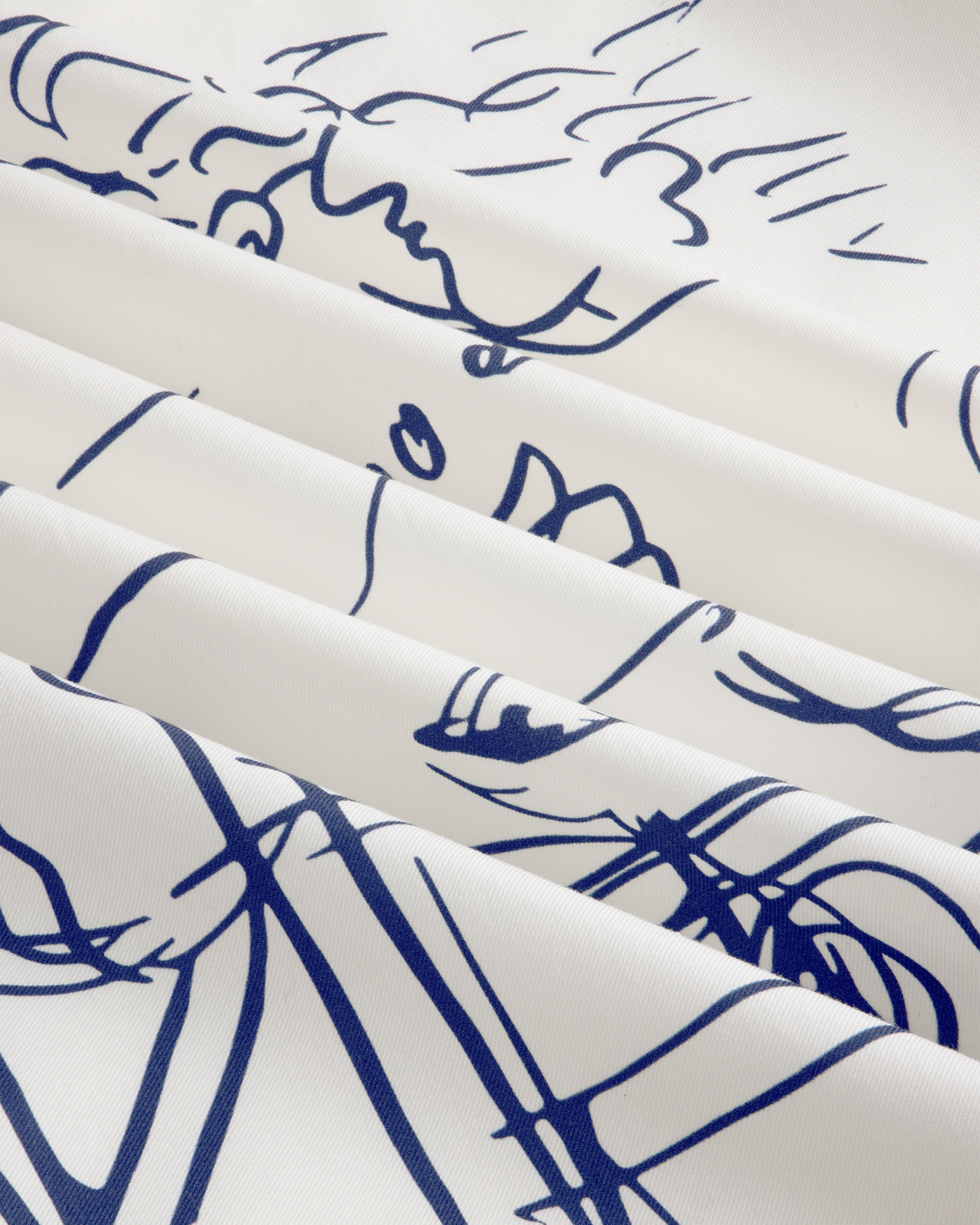The Fassianos "Rendez - Vous" Camp Shirt features white fabric with thin blue line art and soft, diagonal folds.