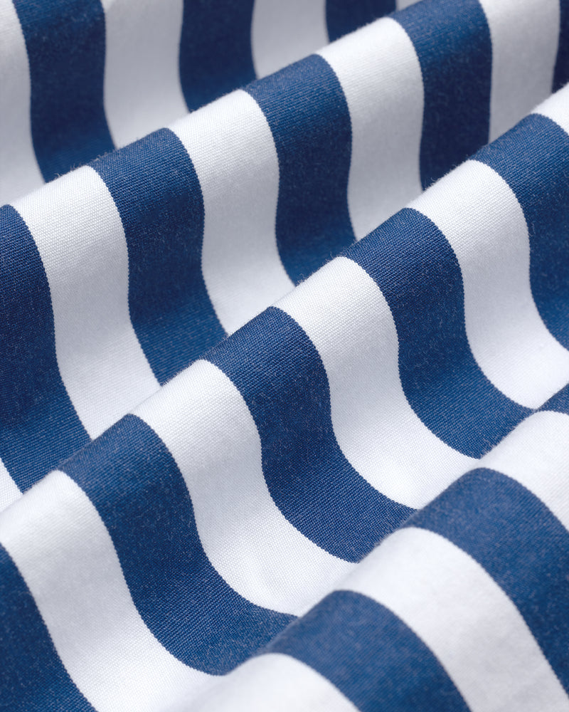 Close-up of blue and white stripes on the Striped Leon Overshirt, fabric softly gathered in waves.