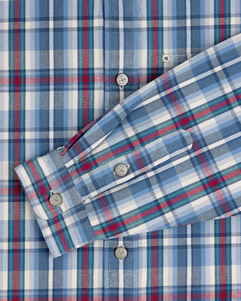 Plaid Work Shirt in blue, white, and red with button-up front and one sleeve laid across the chest.