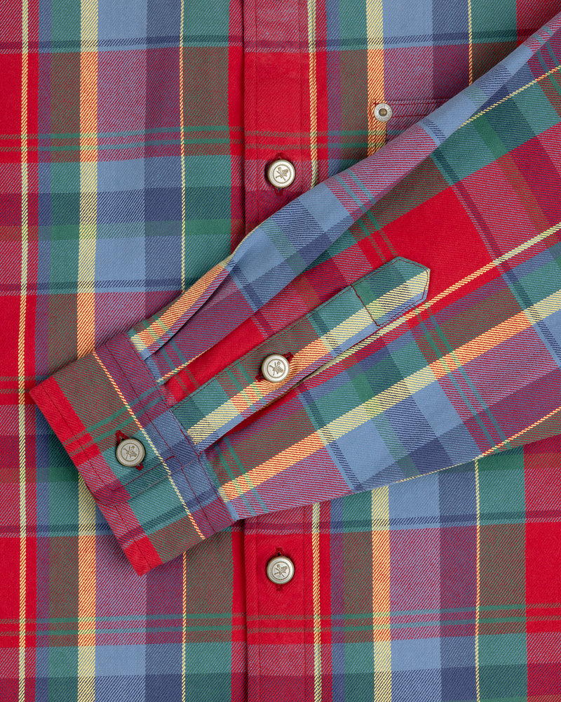 Close-up of Plaid Work Shirt in red, blue, and green with white buttons and detailed cuffs.