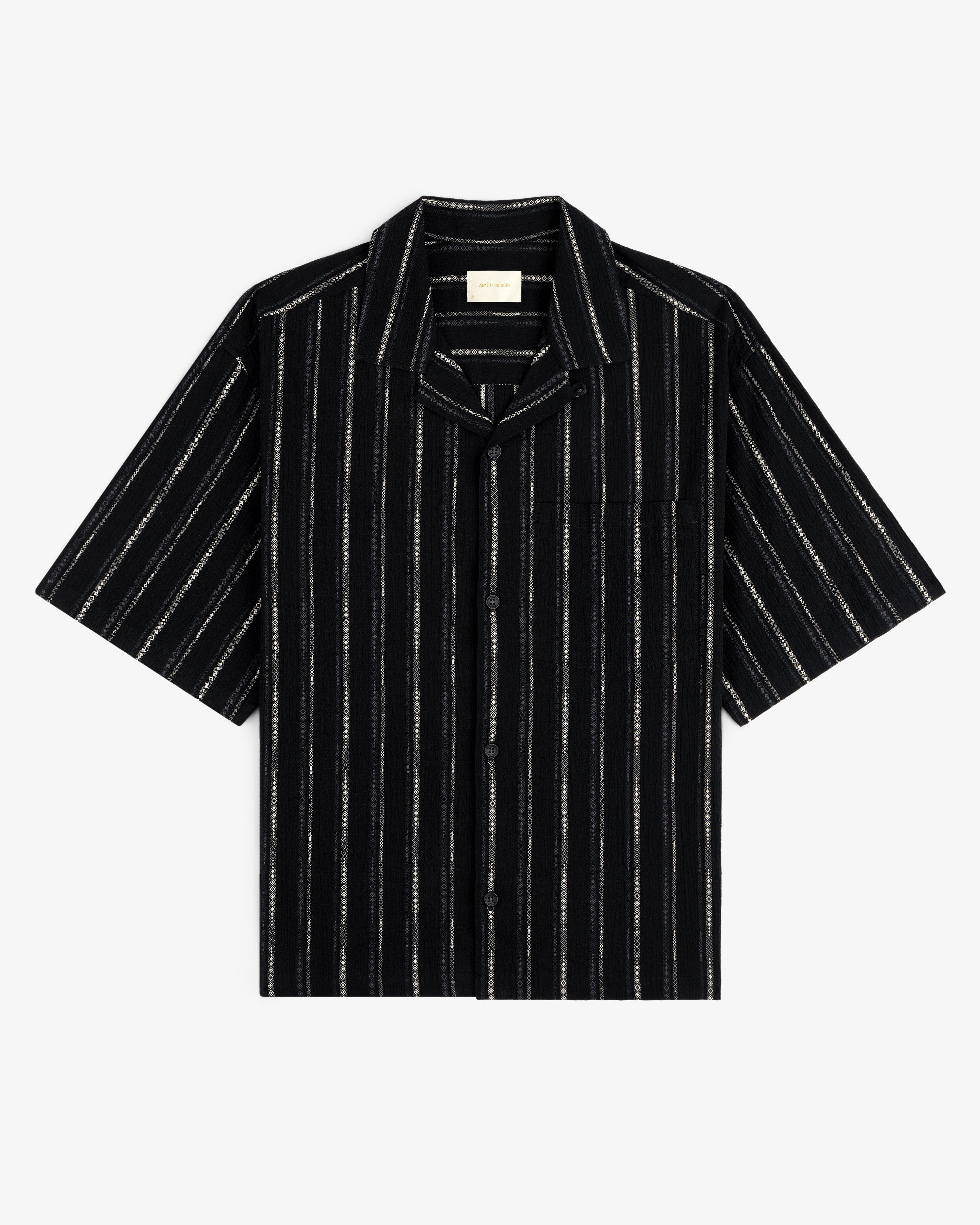 Cropped Jacquard Camp Shirt in black with vertical white stripes and a chest pocket, laid flat on white background.