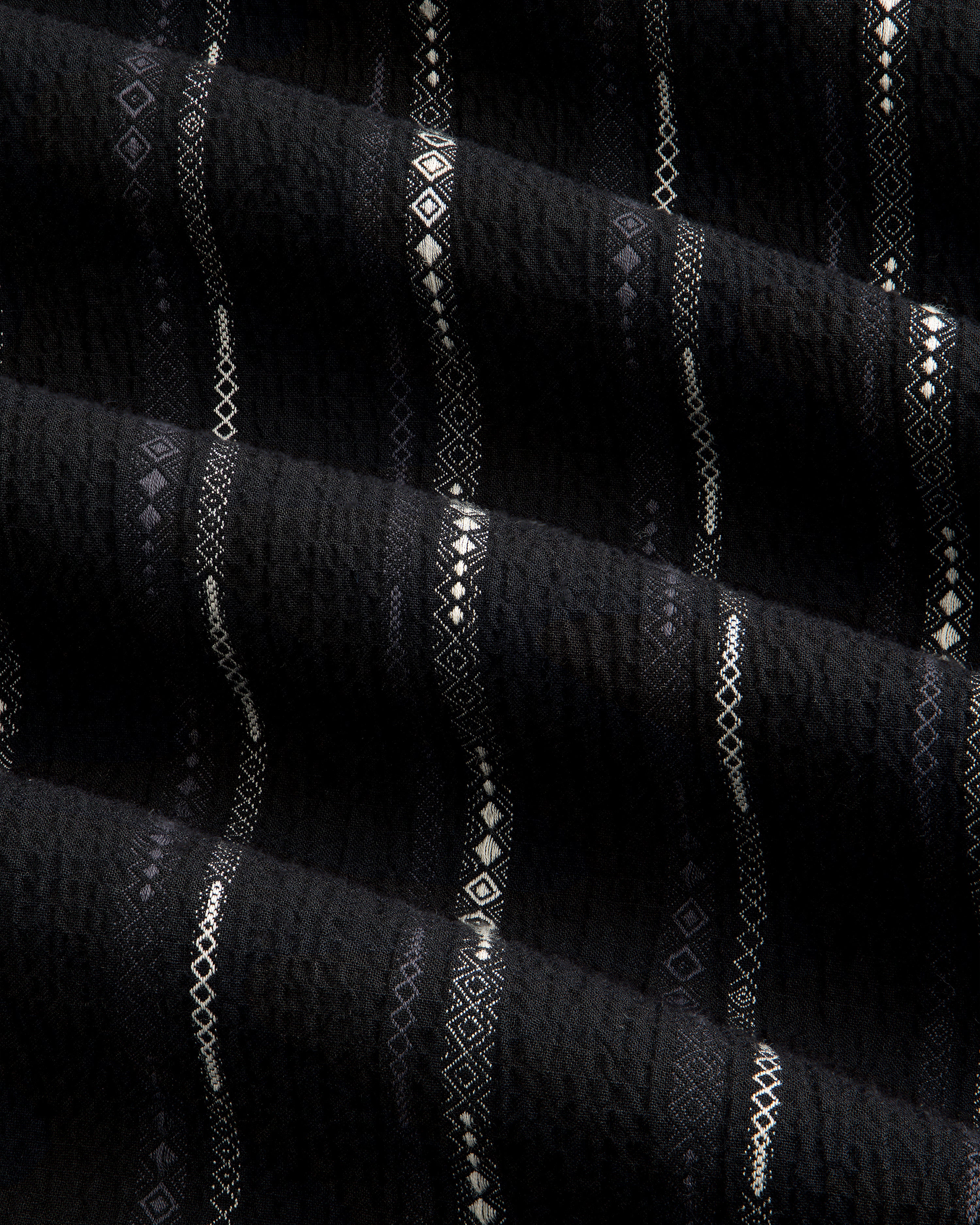 Black Cropped Jacquard Camp Shirt featuring textured fabric with horizontal white geometric patterns and ridges.
