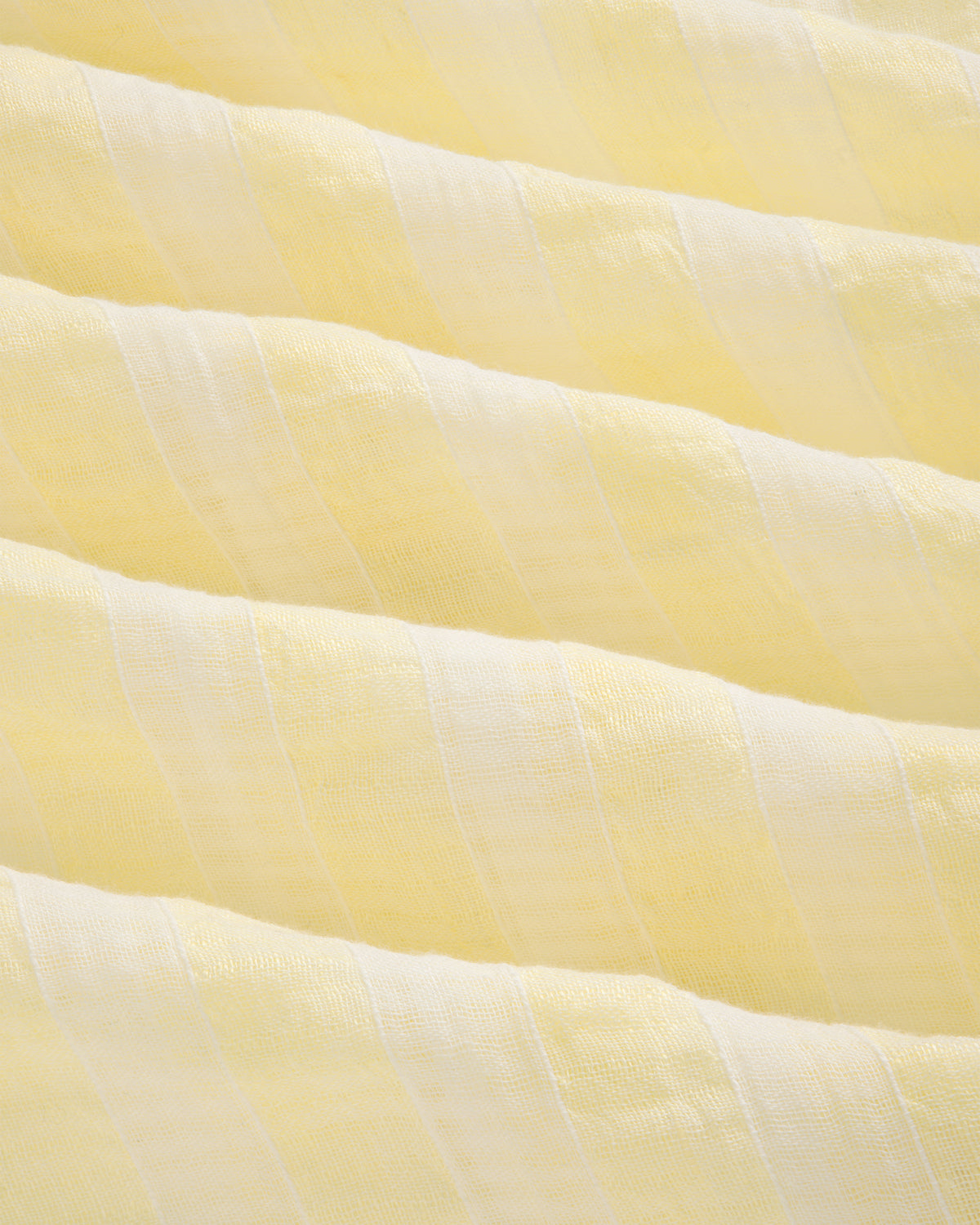 Close-up of Linen Blend Striped Camp Shirt featuring soft, light yellow and white stripes with a wavy texture.