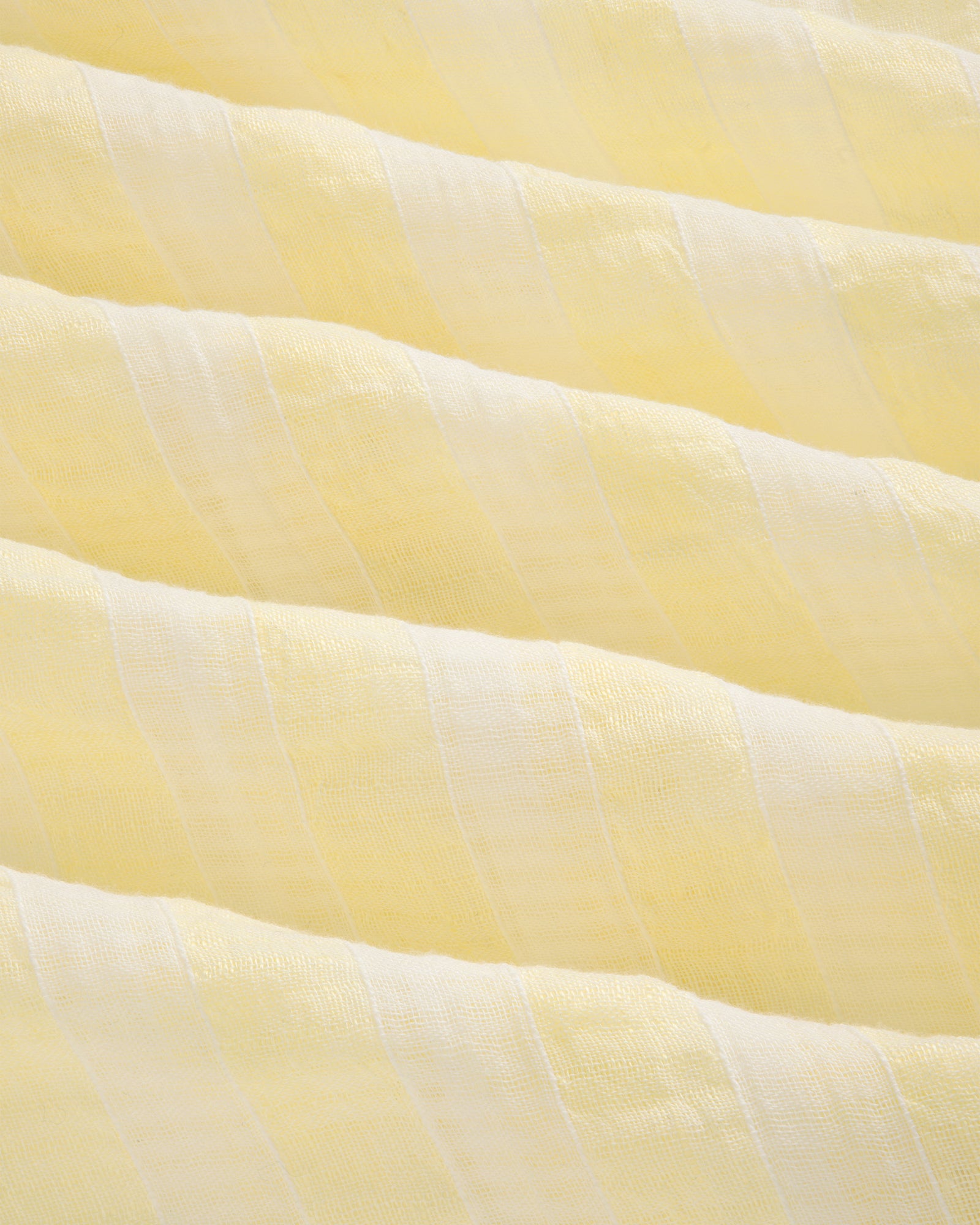 Close-up of Linen Blend Striped Camp Shirt featuring soft, light yellow and white stripes with a wavy texture.