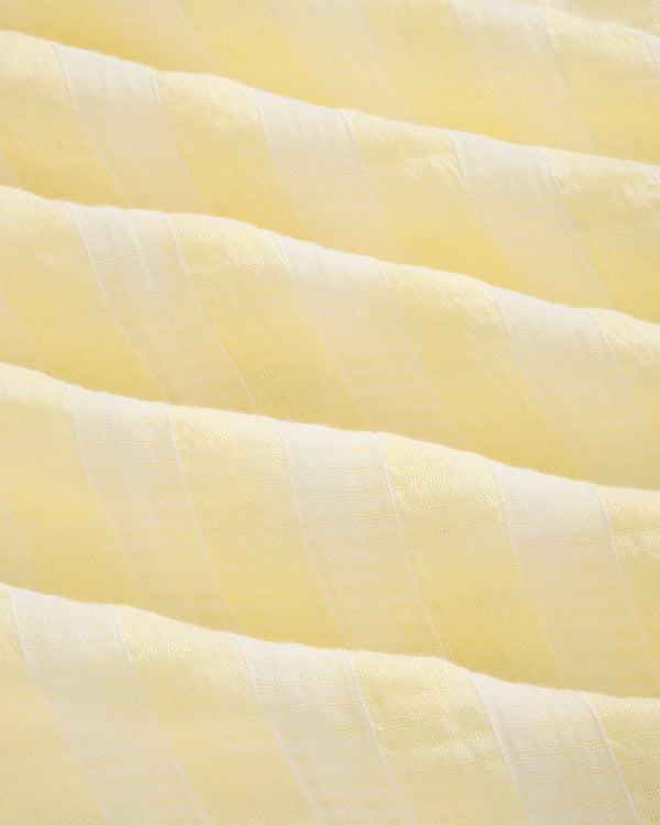Close-up of Linen Blend Striped Camp Shirt featuring soft, light yellow and white stripes with a wavy texture.