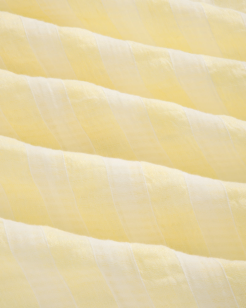 Close-up of Linen Blend Striped Camp Shirt featuring soft, light yellow and white stripes with a wavy texture.
