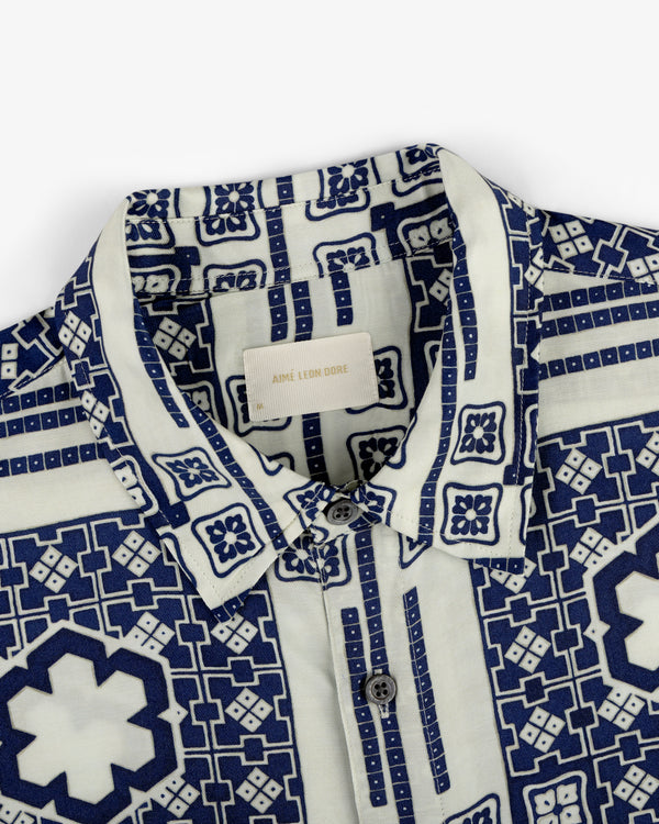 Close-up of the Mosaic Button Down Shirt featuring a blue geometric and floral pattern on a white background.