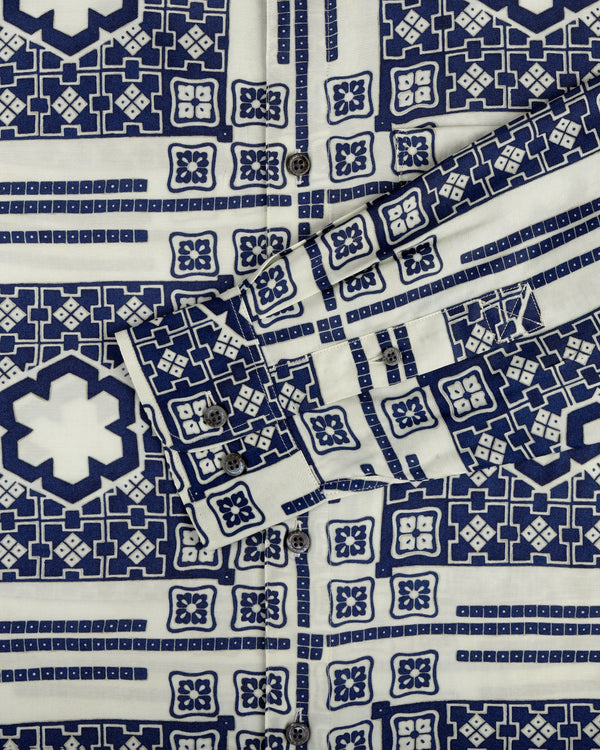 A close-up of the Mosaic Button Down Shirt featuring blue and white geometric patterns and visible buttons.
