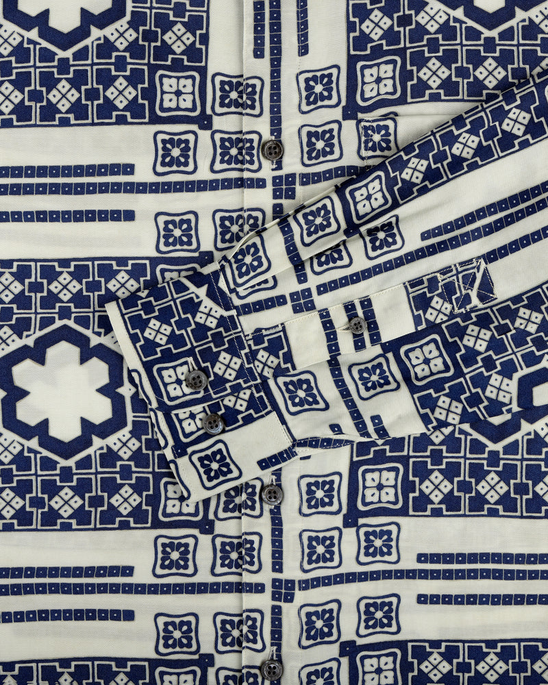 A close-up of the Mosaic Button Down Shirt featuring blue and white geometric patterns and visible buttons.