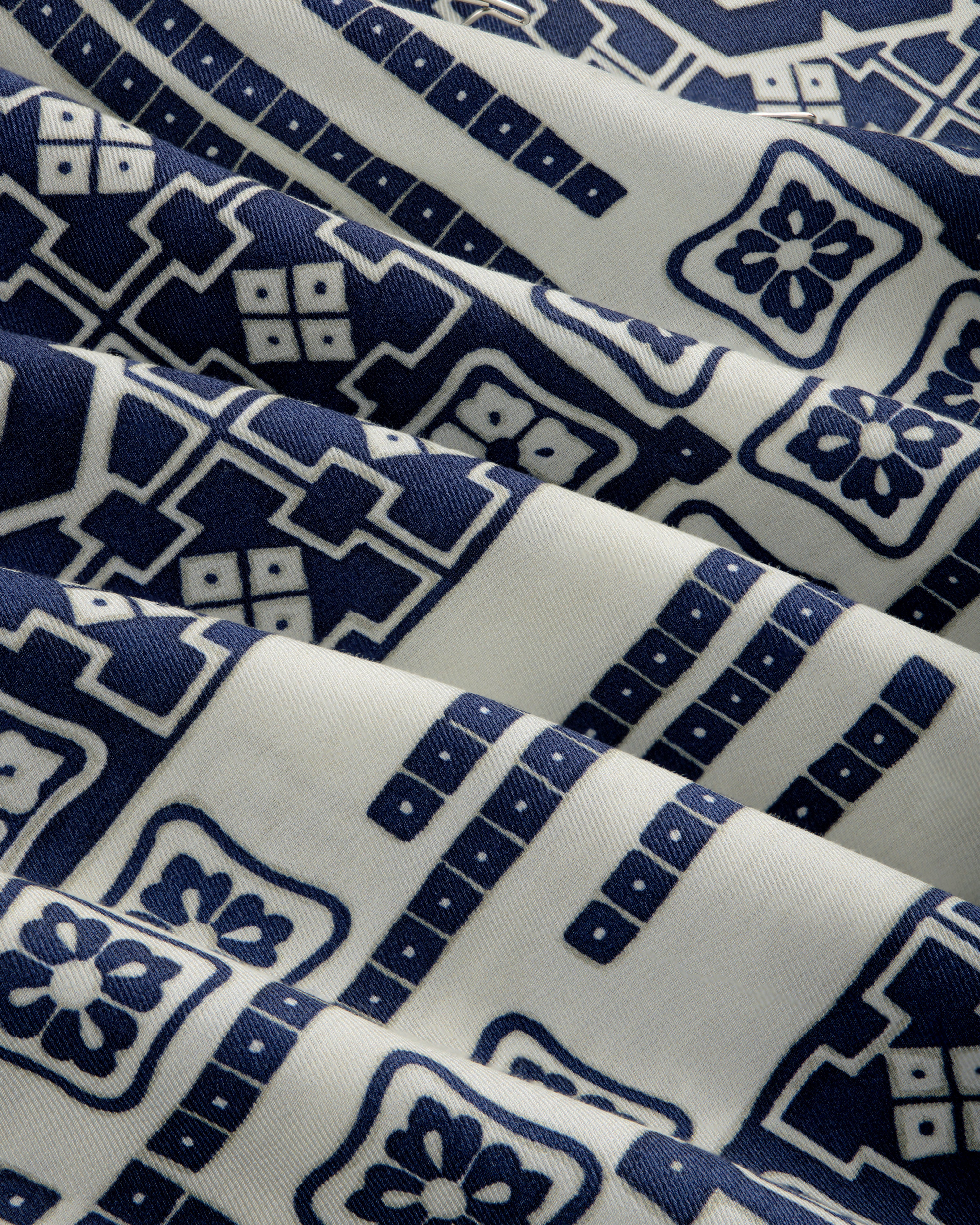 Mosaic Button Down Shirt in cream with blue geometric and floral patterns, draped in soft folds.