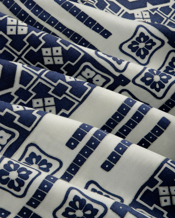 Mosaic Button Down Shirt in cream with blue geometric and floral patterns, draped in soft folds.