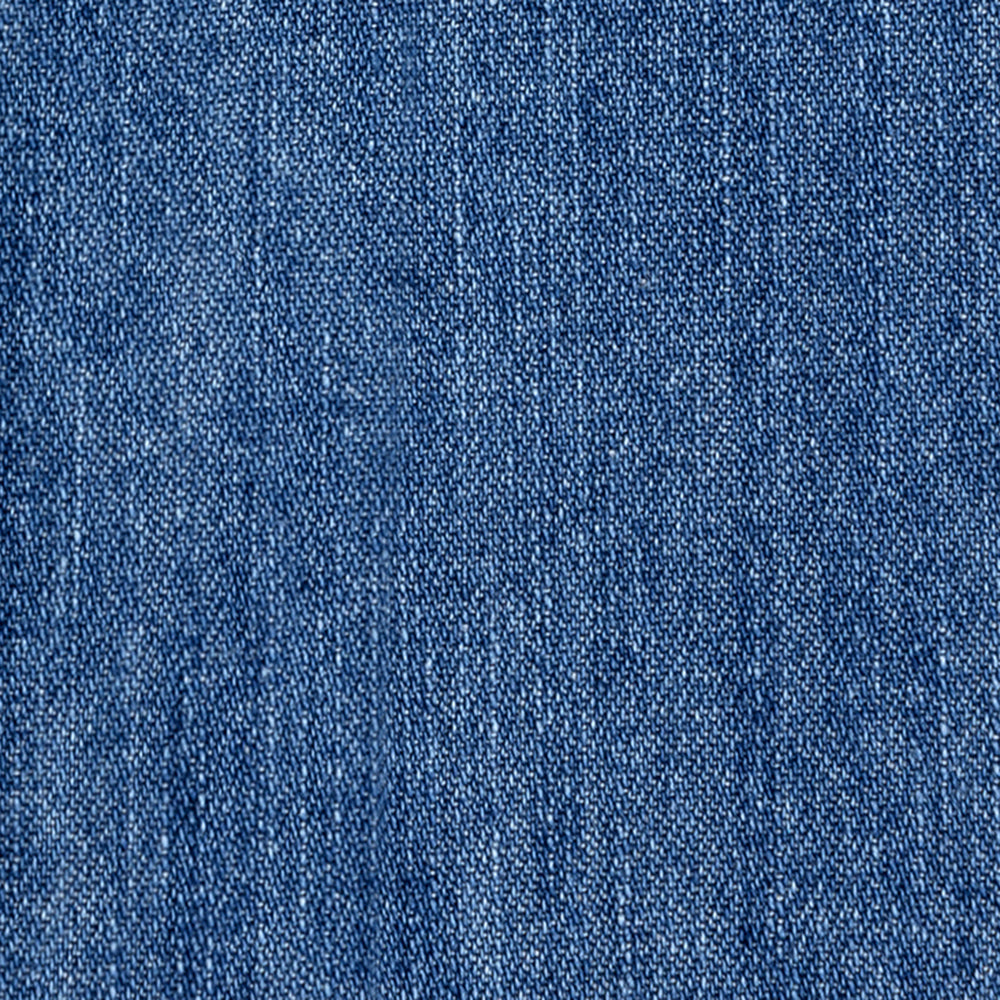 Close-up of Crest Chambray Shirt's blue denim, highlighting its detailed woven texture and gentle fading.