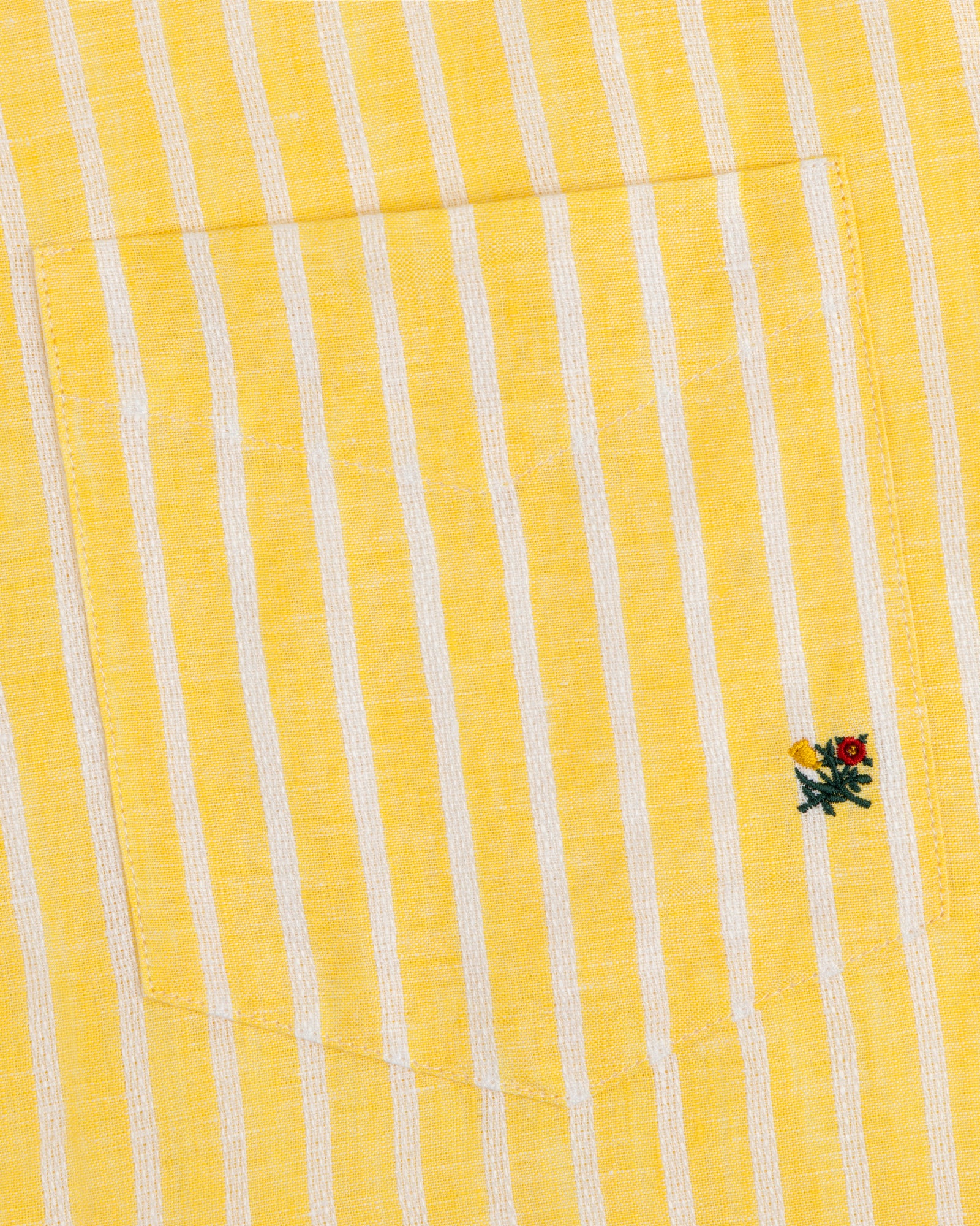 Striped Linen Casual Shirt with yellow and white stripes, pocket, and small embroidered flower near the pocket edge.