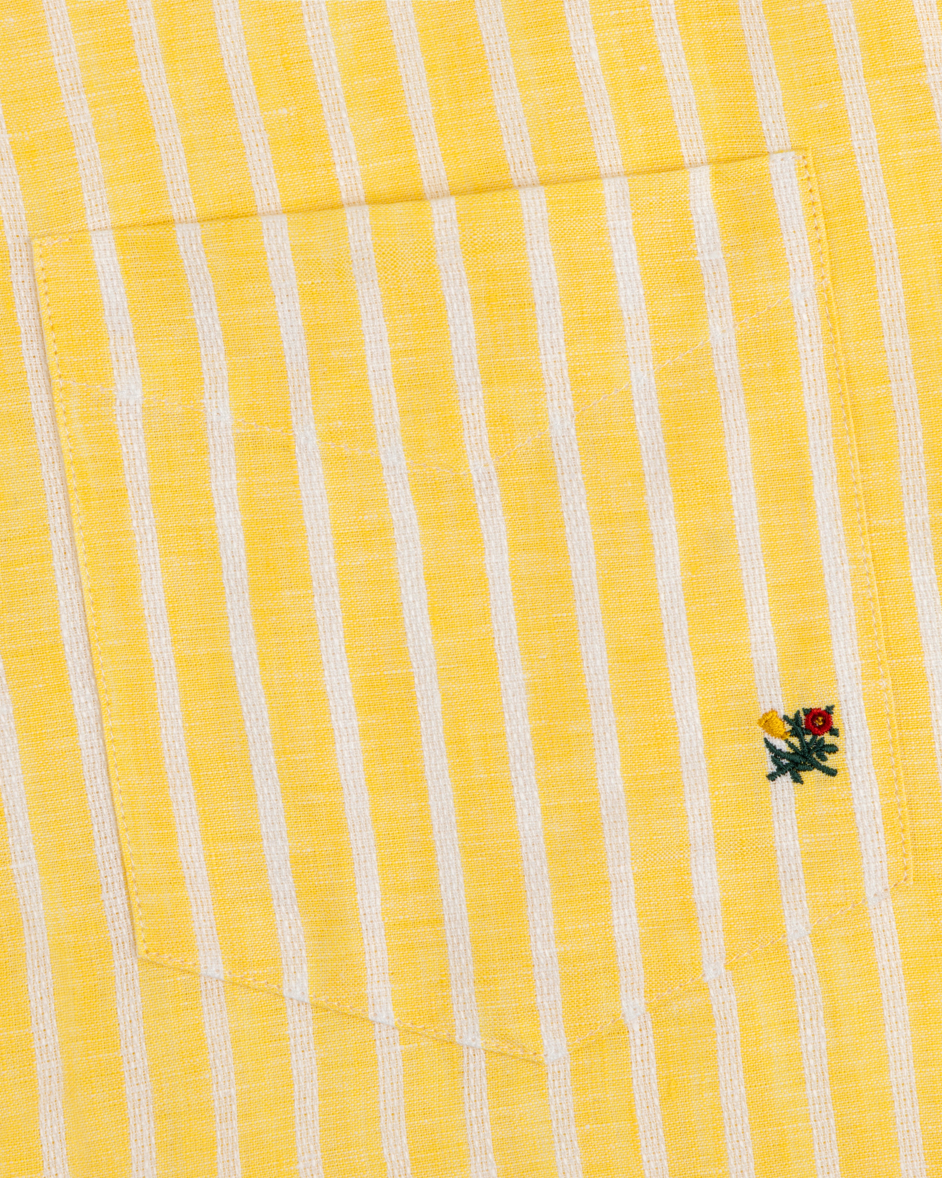 Striped Linen Casual Shirt with yellow and white stripes, pocket, and small embroidered flower near the pocket edge.