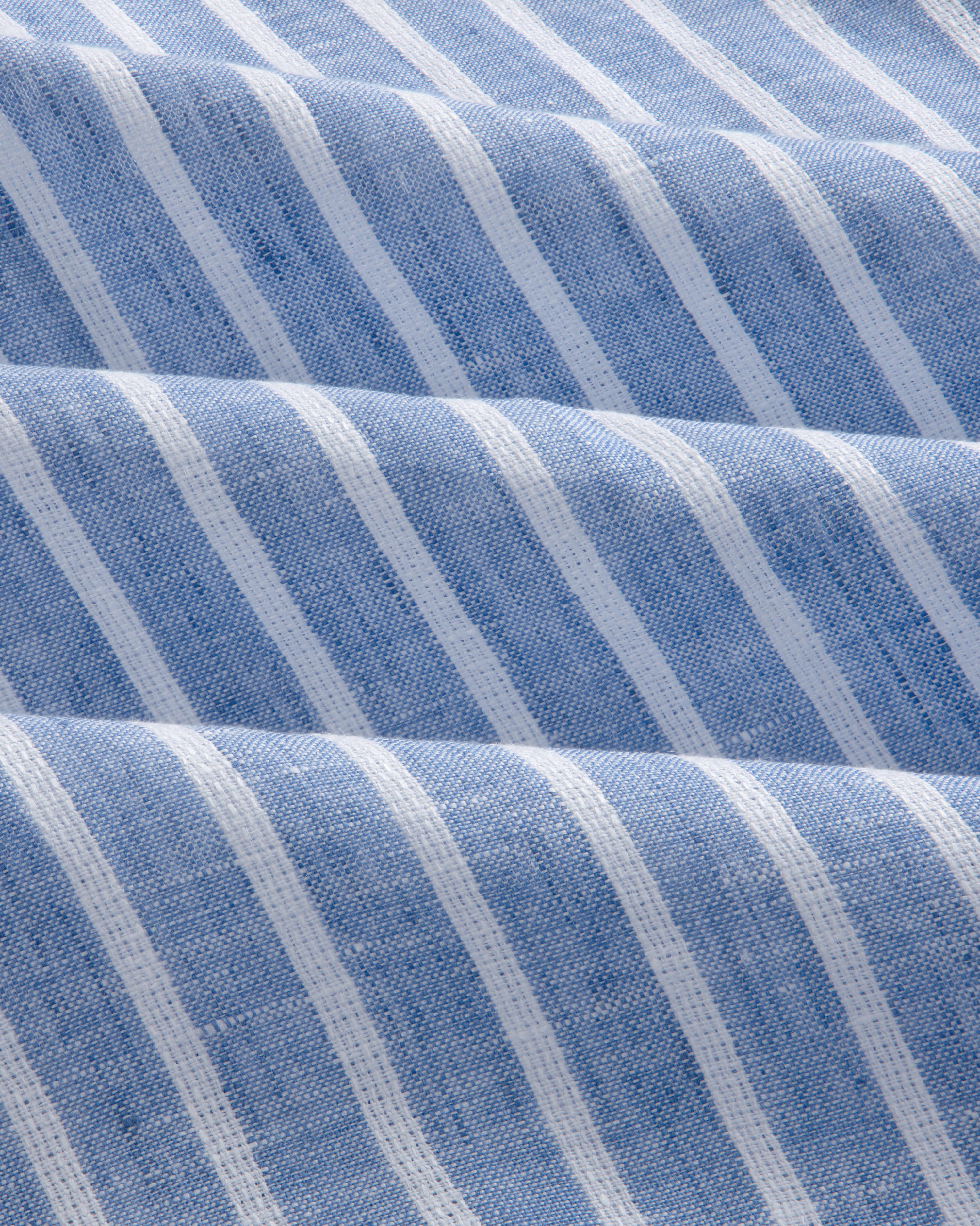 Close-up of the Striped Linen Casual Shirt in light blue, featuring vertical white stripes and a textured surface.