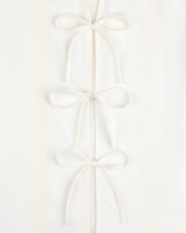 Three Jacquard Striped Tie-Front Shirts are stacked vertically on a white textured background.