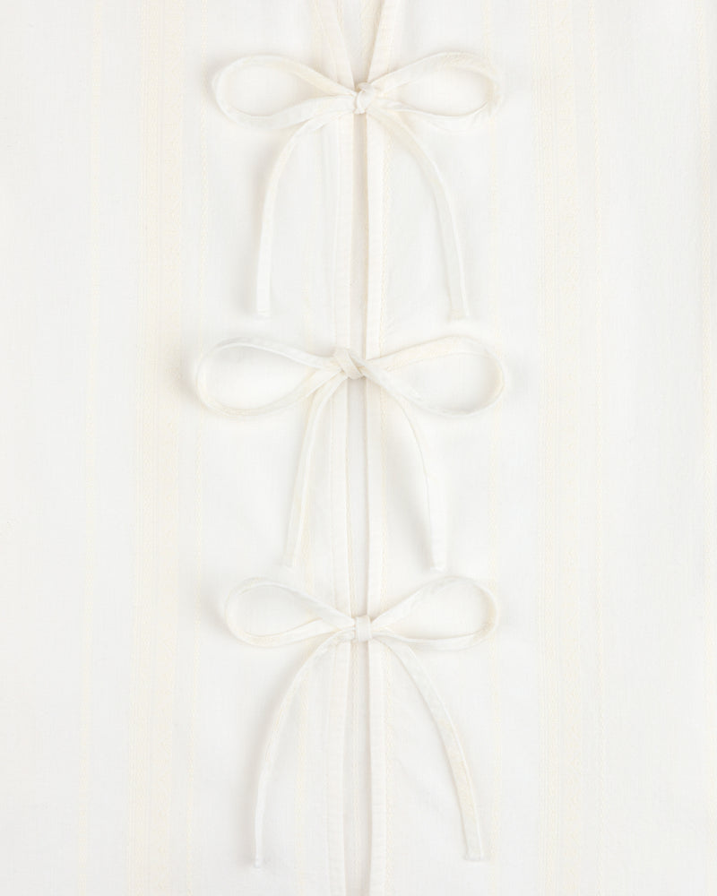 Three Jacquard Striped Tie-Front Shirts are stacked vertically on a white textured background.