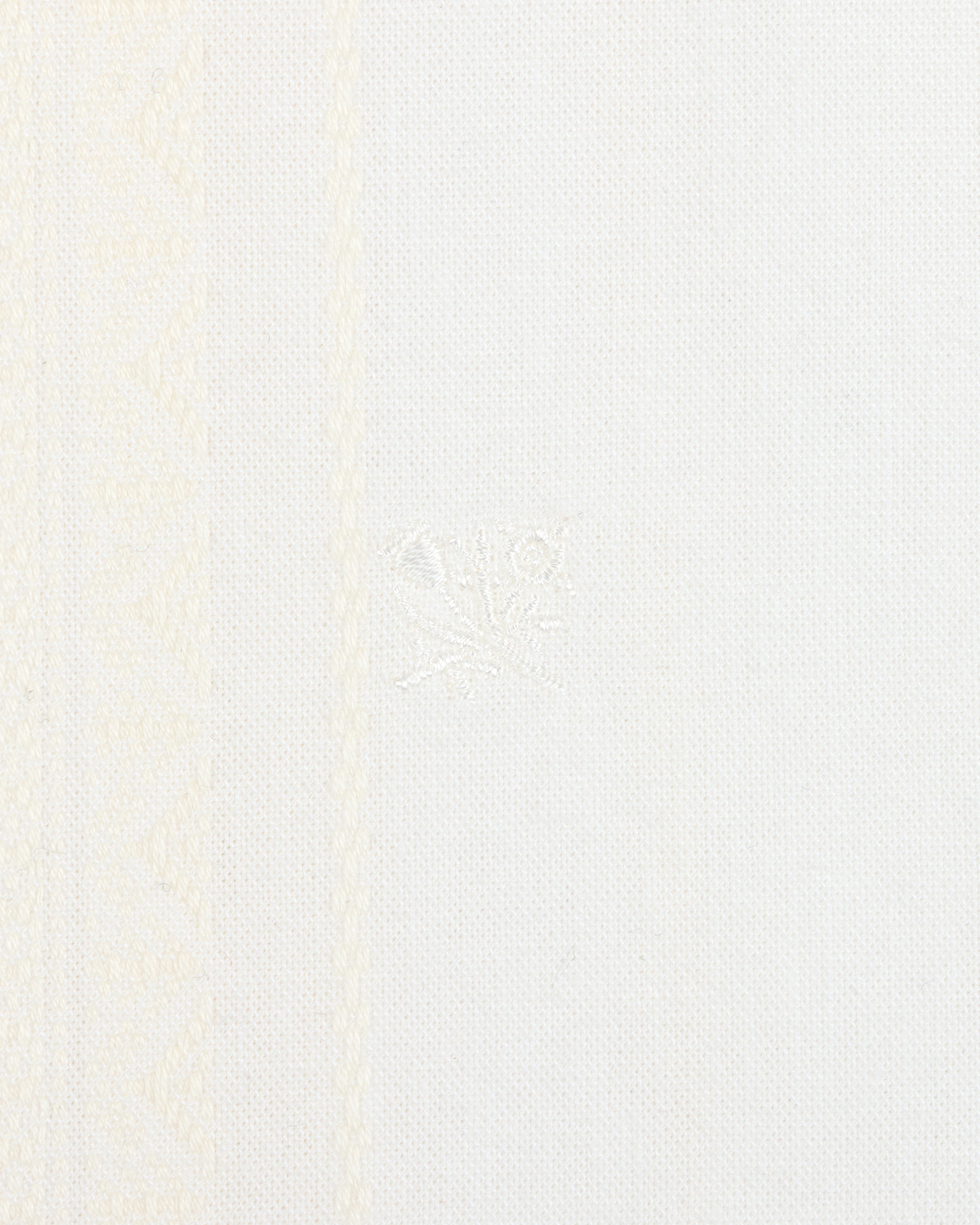 Close-up of the Jacquard Striped Tie-Front Shirt's white textured fabric with subtle patterns and a central embroidered detail.