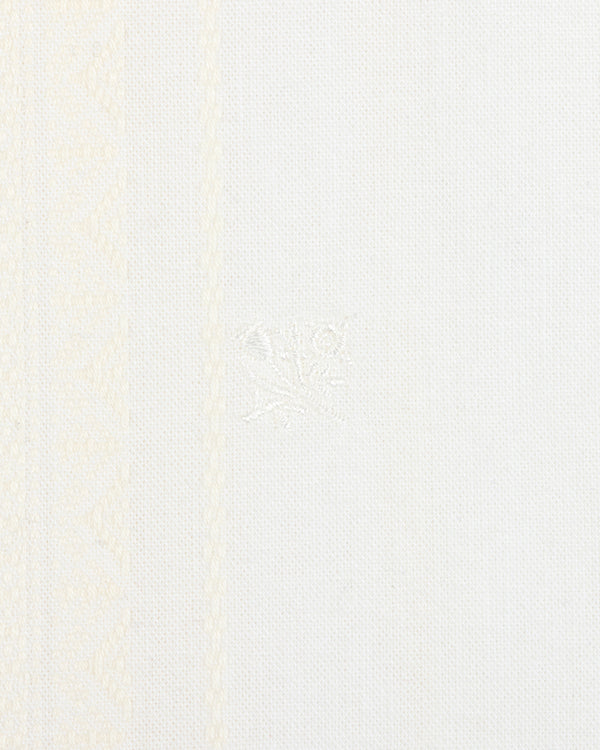 Close-up of the Jacquard Striped Tie-Front Shirt's white textured fabric with subtle patterns and a central embroidered detail.