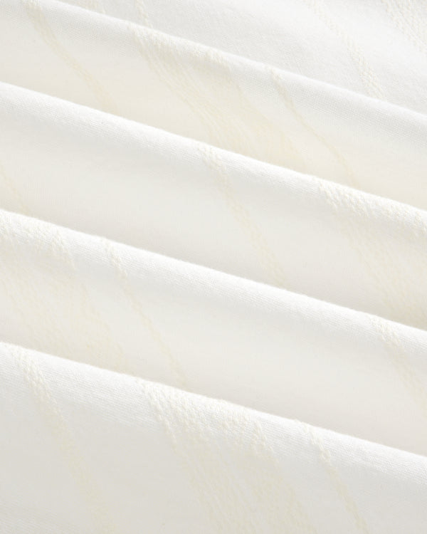 Close-up of Jacquard Striped Tie-Front Shirt showing folded white fabric with subtle diagonal textured lines.