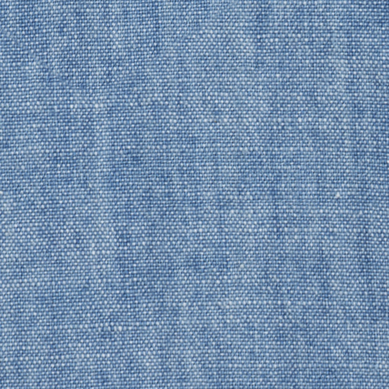 Close-up of Crest Chambray Shirt's blue fabric highlighting its woven texture and fine threads.