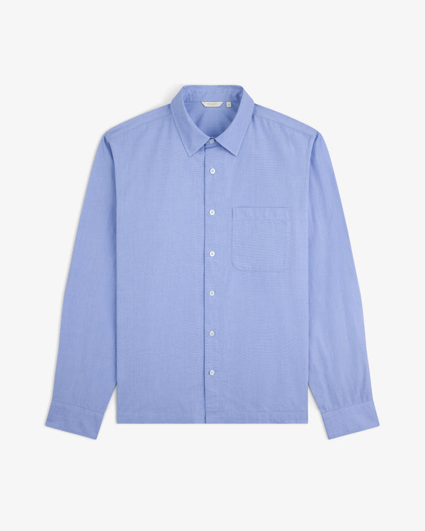 Poplin Casual Shirt in light blue, long-sleeve with chest pocket, laid flat on a white background.