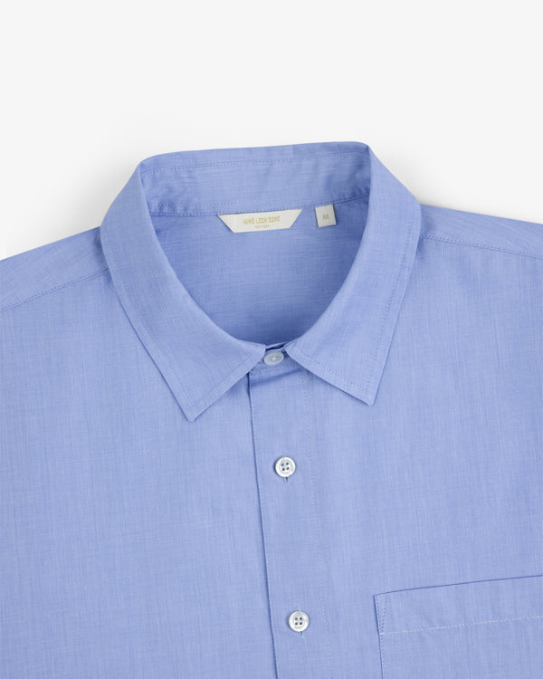 Poplin Casual Shirt in light blue with collar and chest pocket, shown on a white background.