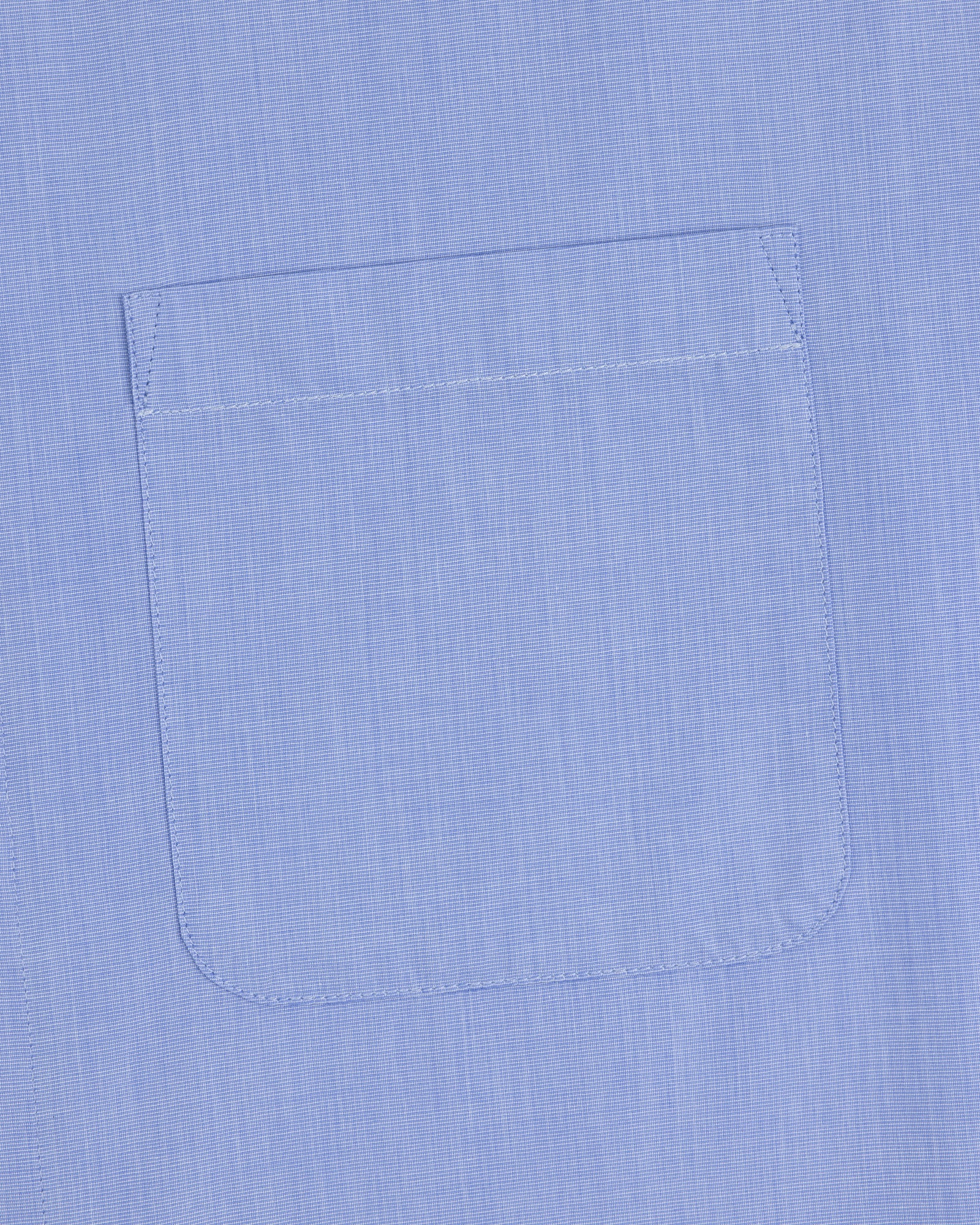 A close-up of the Poplin Casual Shirt pocket in light blue, showing visible stitching on smooth fabric.