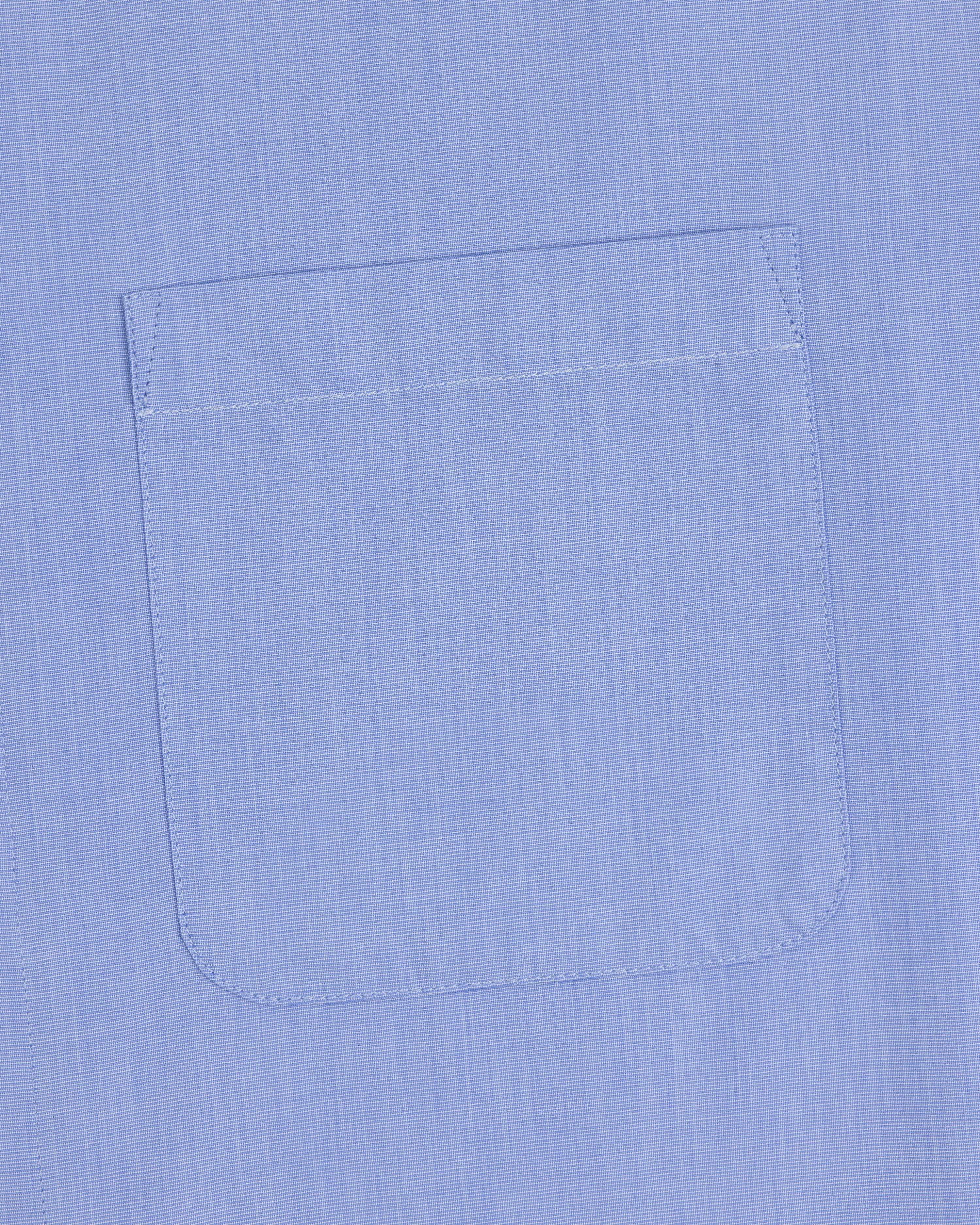 A close-up of the Poplin Casual Shirt pocket in light blue, showing visible stitching on smooth fabric.