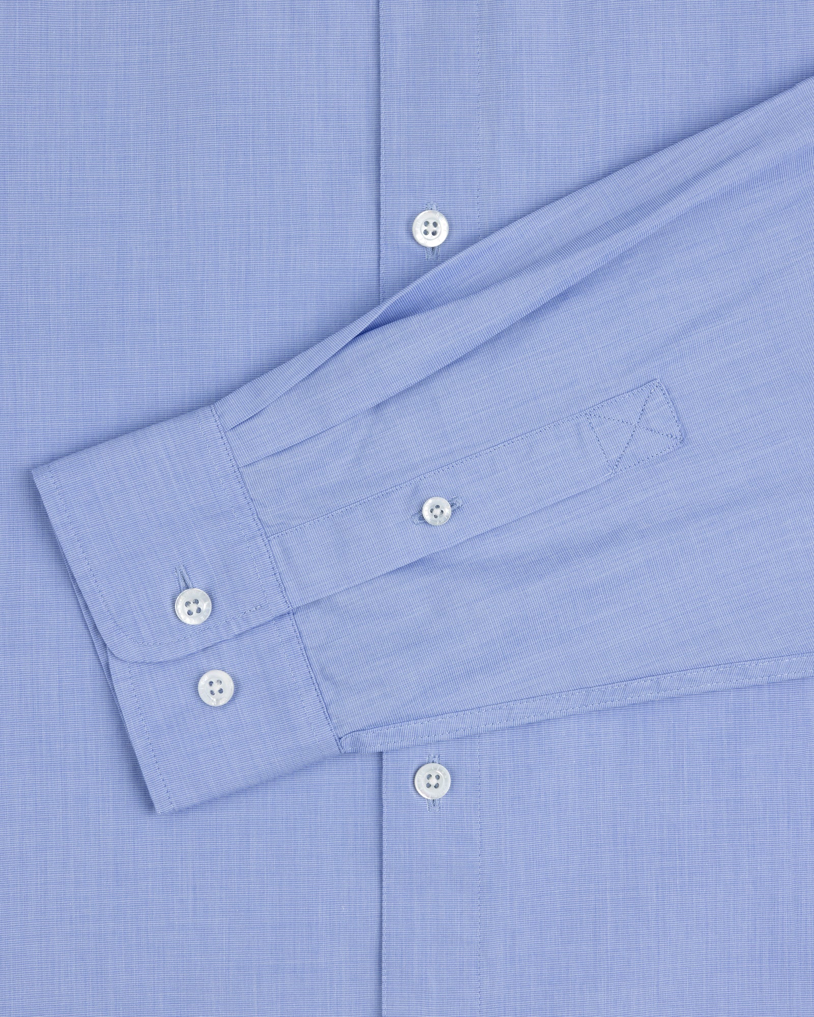 The Poplin Casual Shirt in light blue features white buttons and a left sleeve laid flat across the torso.