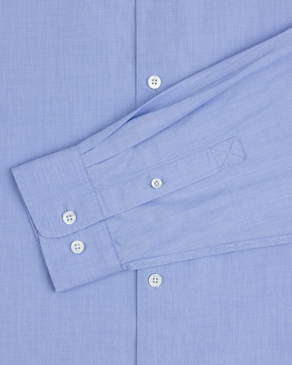 The Poplin Casual Shirt in light blue features white buttons and a left sleeve laid flat across the torso.