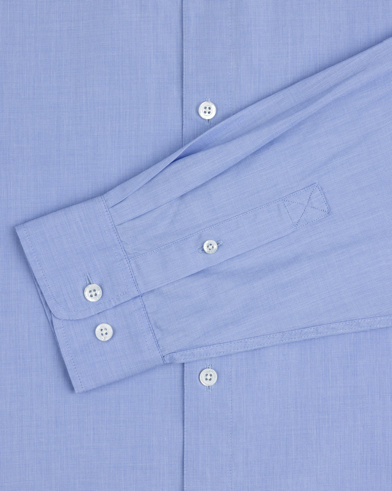 The Poplin Casual Shirt in light blue features white buttons and a left sleeve laid flat across the torso.