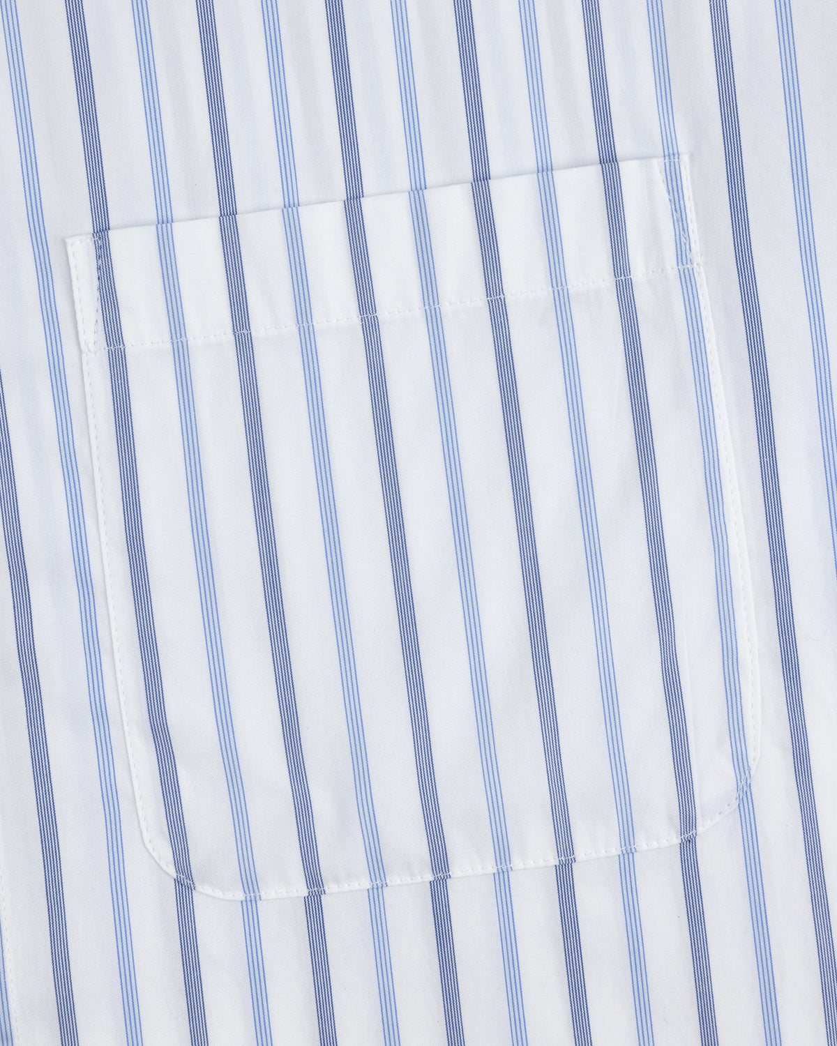 Close-up of Poplin Casual Shirt pocket on white fabric with vertical blue and light blue stripes.
