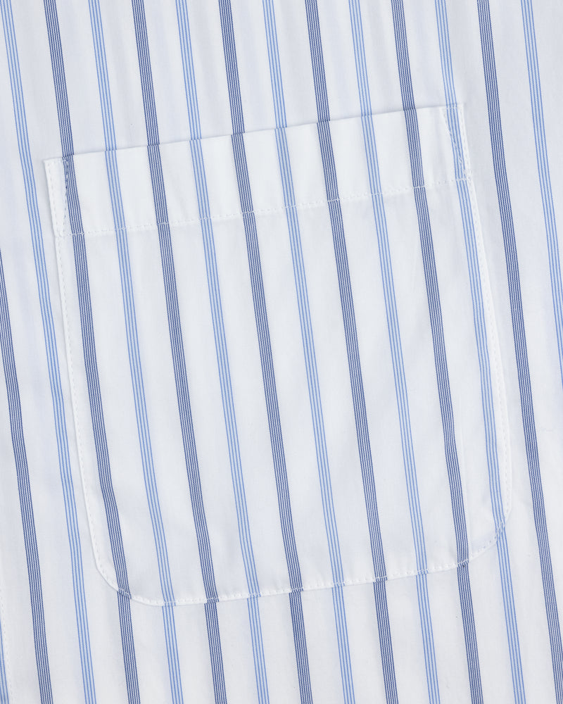 Close-up of Poplin Casual Shirt pocket on white fabric with vertical blue and light blue stripes.
