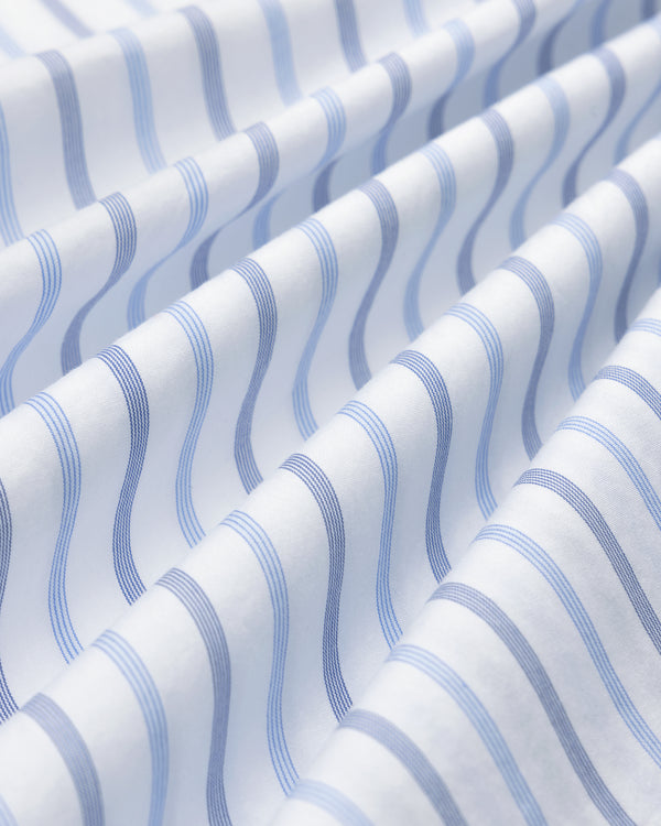 Close-up of Poplin Casual Shirt: white fabric with wavy blue stripes, gentle folds, and soft texture.