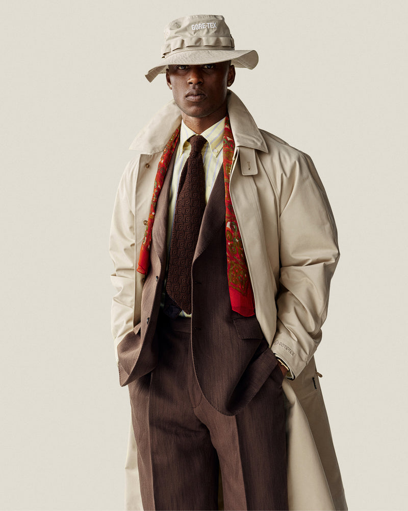 A man in a Yarn Dyed Striped Crest Shirt stands confidently.