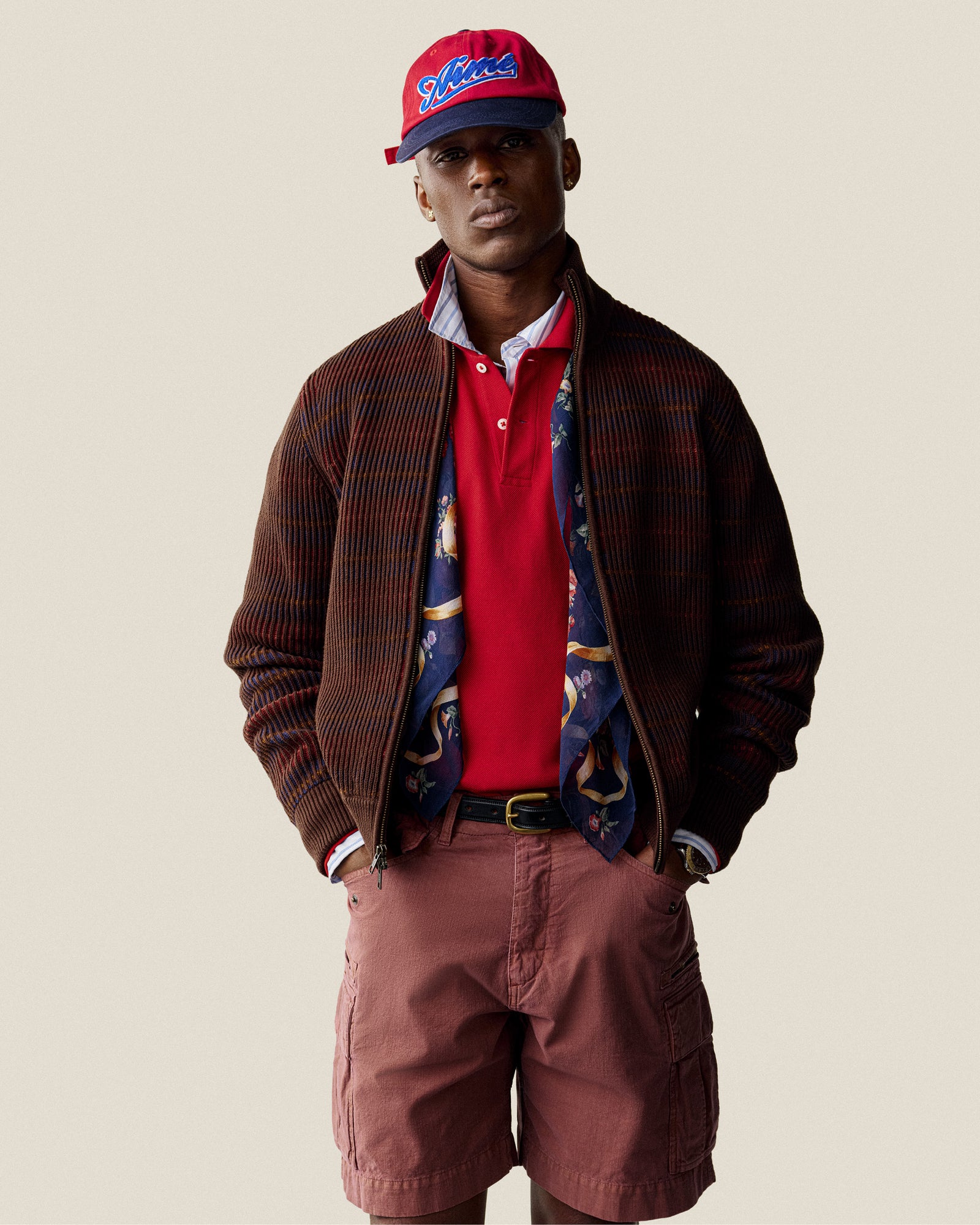 Man wearing a Multi Color Knit Track Sweater, standing against a plain background.