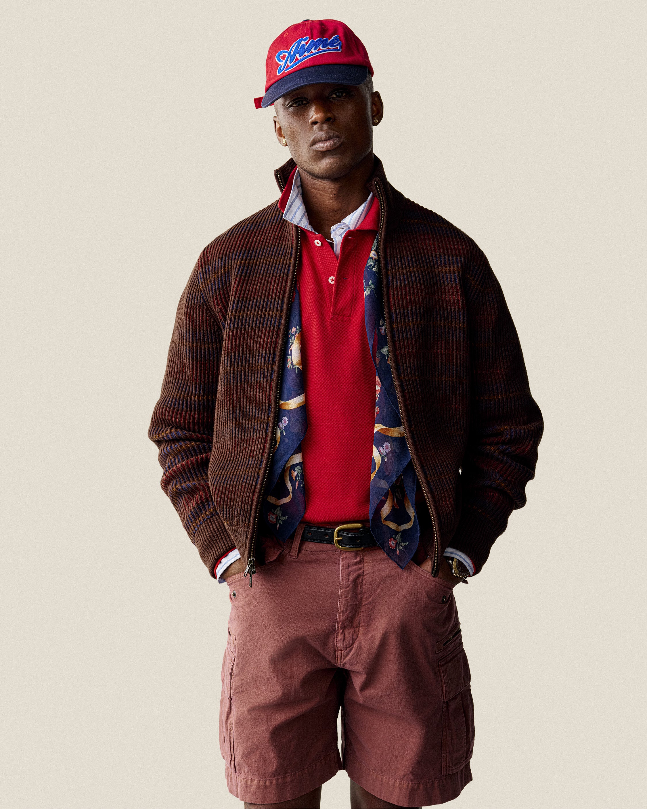 Man wearing a Multi Color Knit Track Sweater, standing against a plain background.