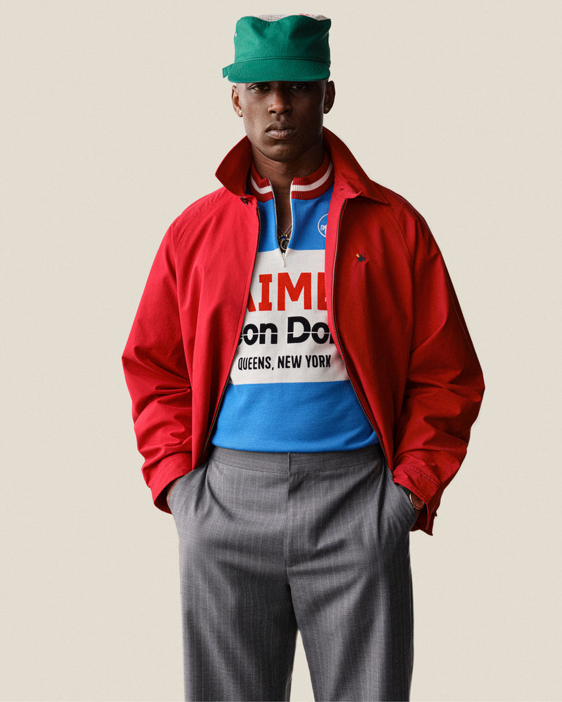 A man in a Merino Wool Cycling Jersey stands with hands in pockets against a plain background.