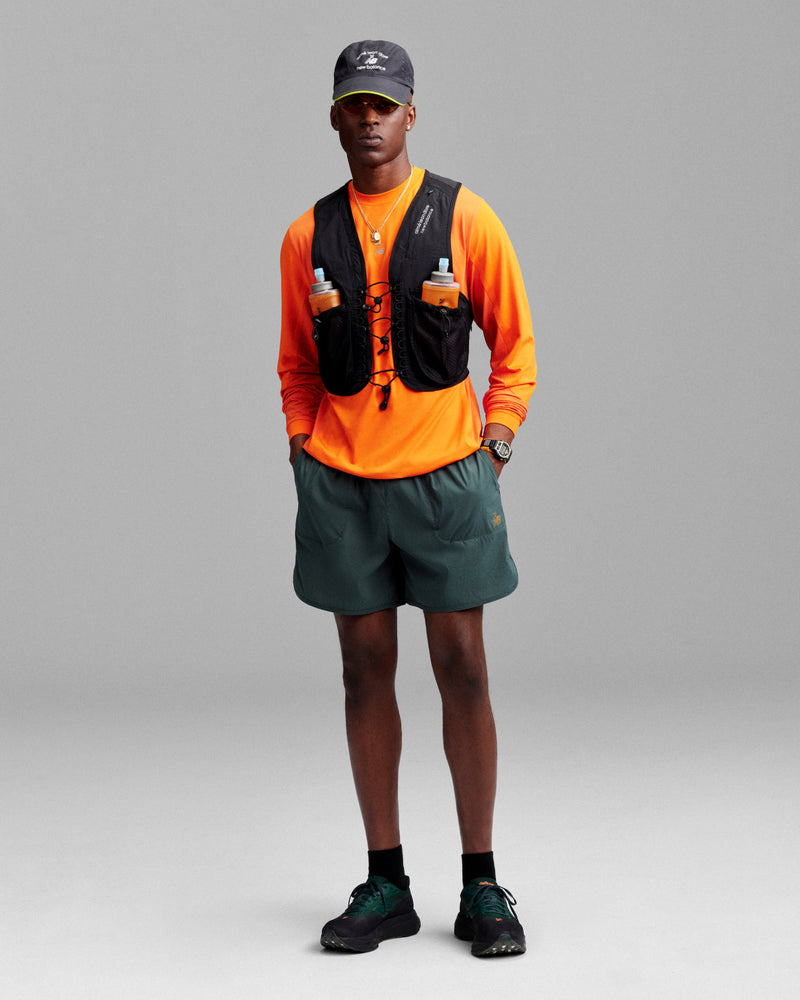 A person in the ALD / New Balance Performance Long-Sleeve Tee stands against a gray background.