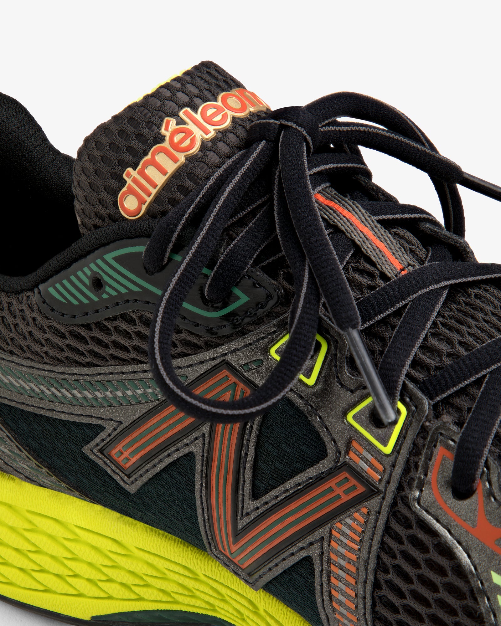 Close-up of the ALD / New Balance 860v2 black sneaker with colorful accents, mesh texture, and branded tongue.