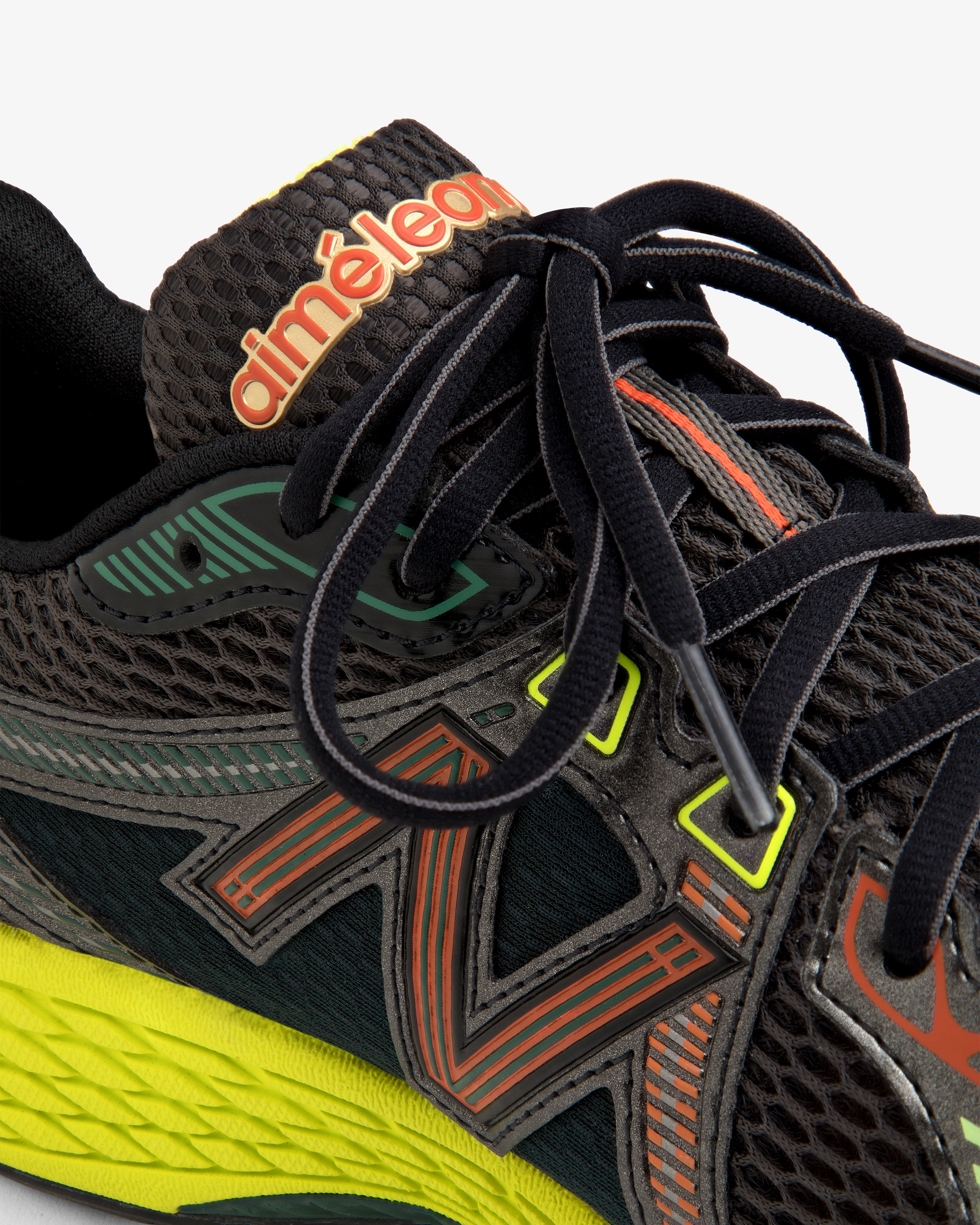 Close-up of the ALD / New Balance 860v2 black sneaker with colorful accents, mesh texture, and branded tongue.
