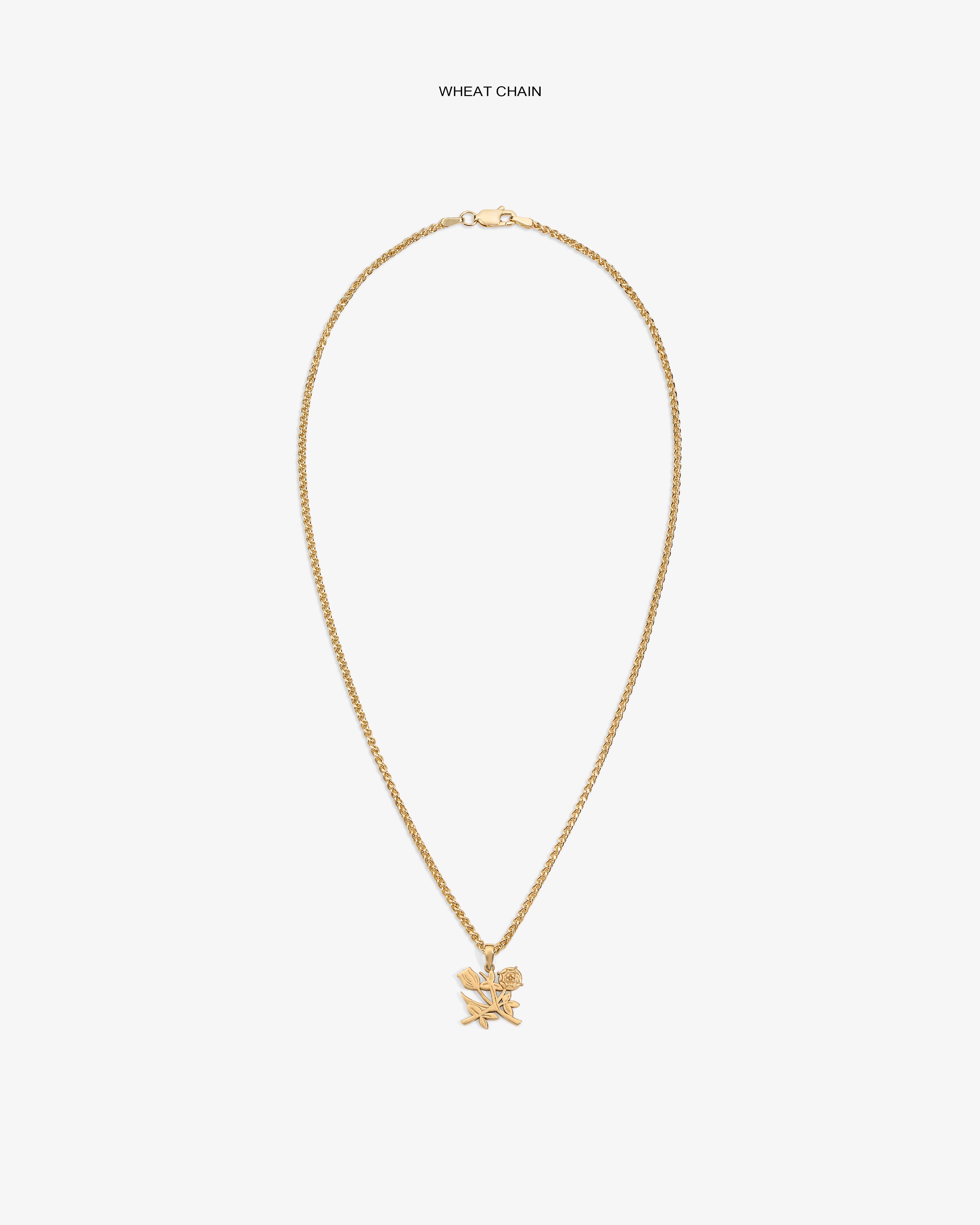 14Kt Gold Pendant necklace with a wheat chain and star pendant on a plain white background.