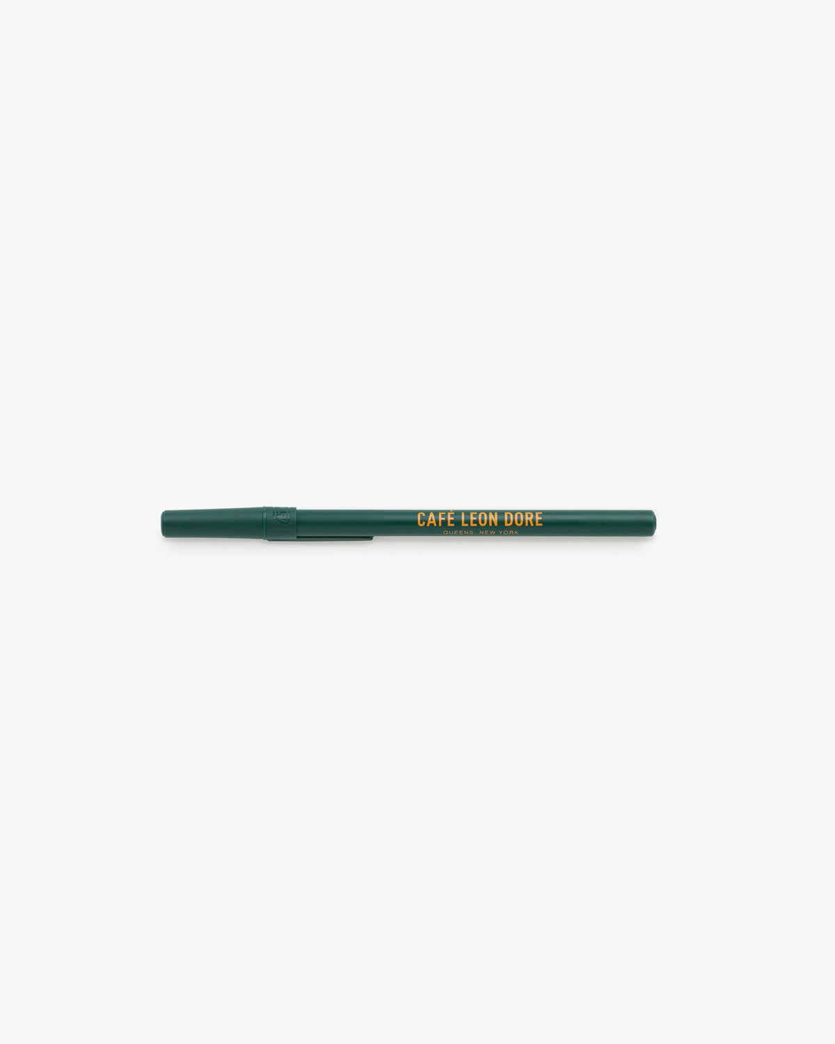 A Café Leon Dore Ballpoint Pen with a green cap and yellow logo on barrel, displayed on a white background.