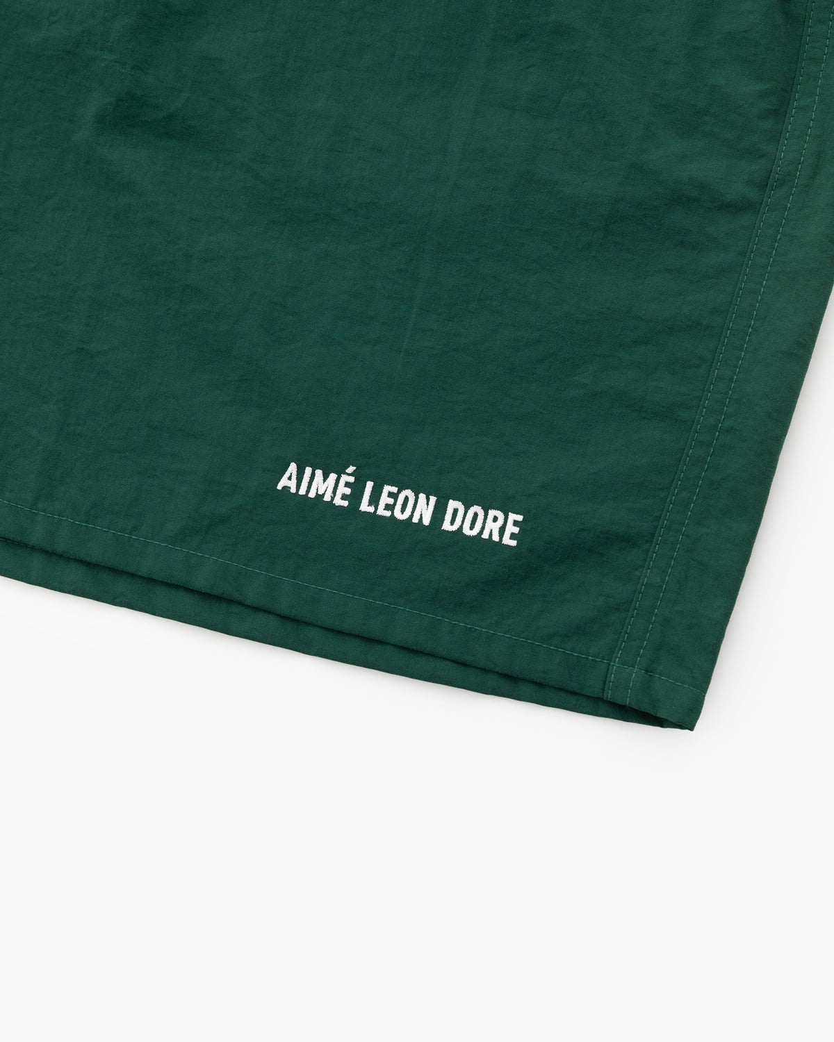 Dark green Logo Swim Short with AIMÉ LEON DORE printed in white near the edge.
