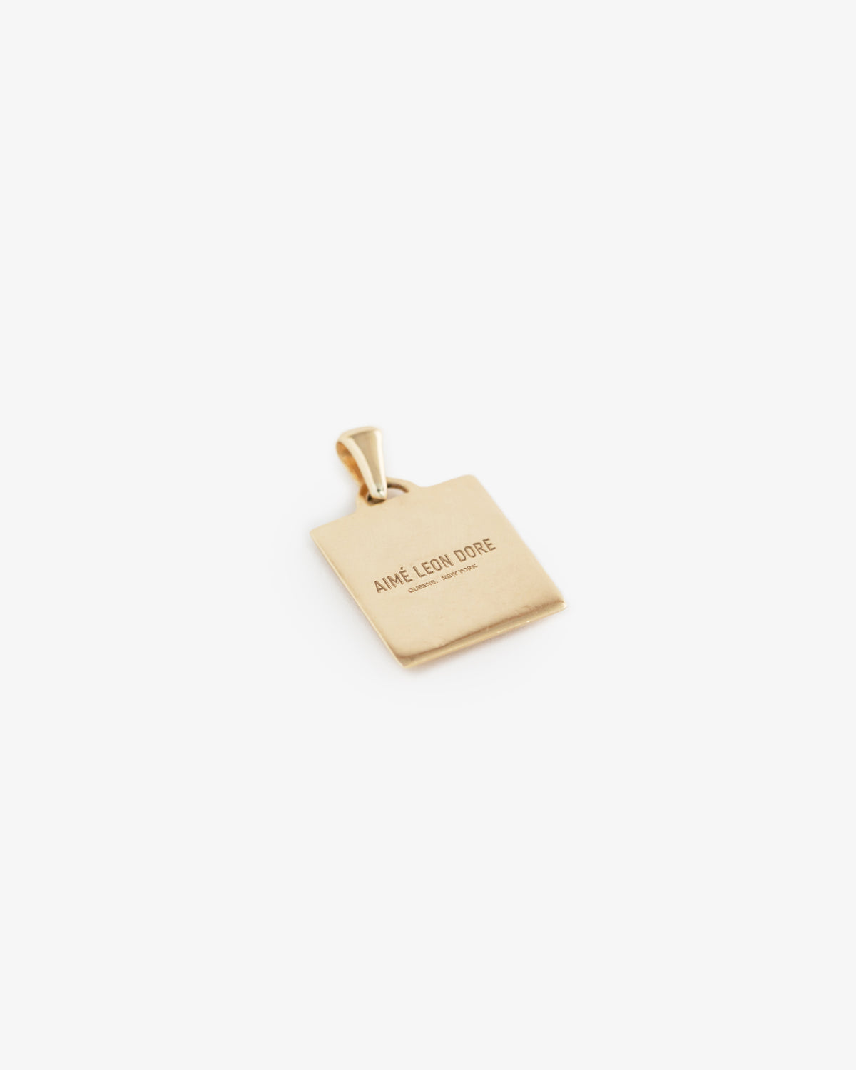 14Kt Gold Pendant, rectangular with AIMÉ LEON DORE engraved, displayed on a plain white background.