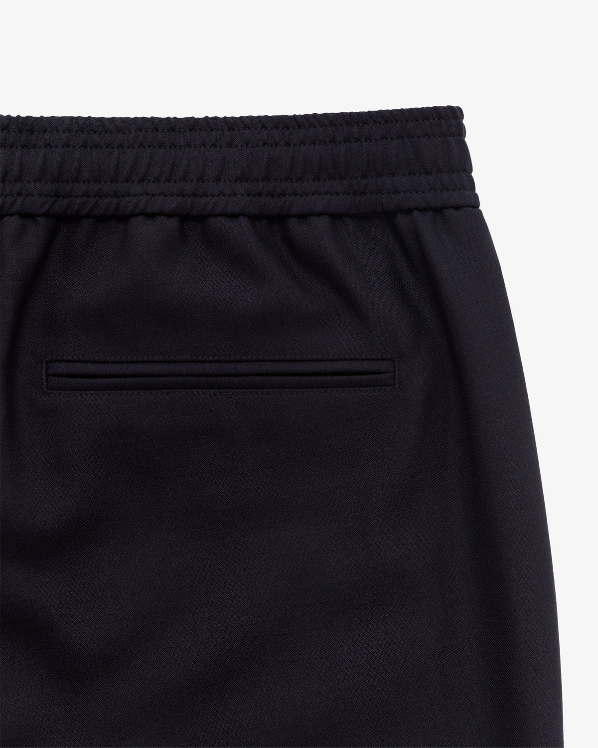 Close-up of Tropical Wool Elasticated Waist Suit Trouser in black with an elastic waistband and single back welt pocket.