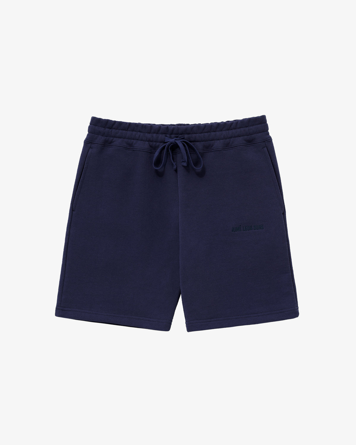 Tonal Logo Sweatshorts in navy blue with side pockets, elastic waistband, and subtle left-leg logo, shown laid flat.