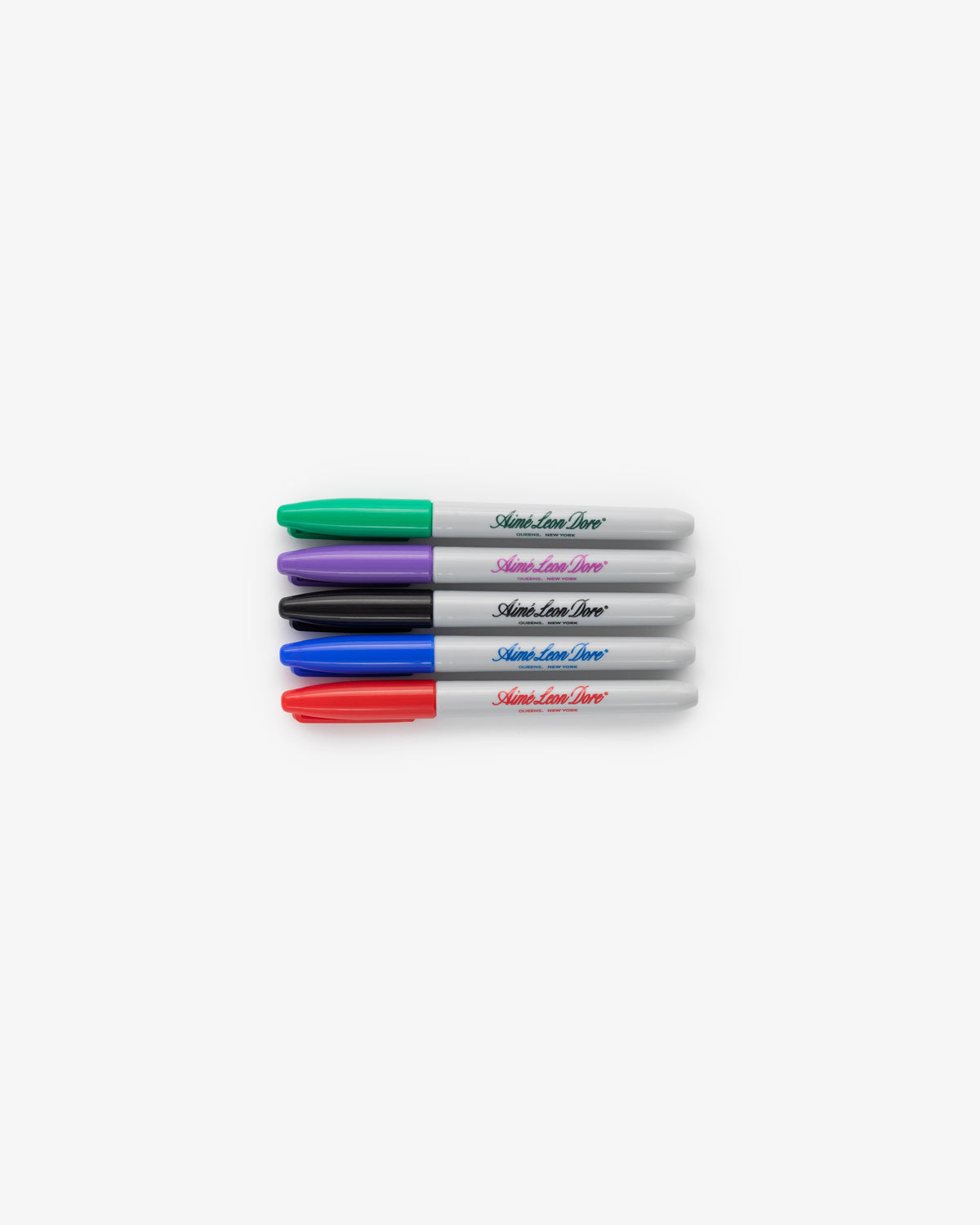 Sharpie 5 Pack markers with caps in green, purple, black, and red, lined up horizontally on a white background.